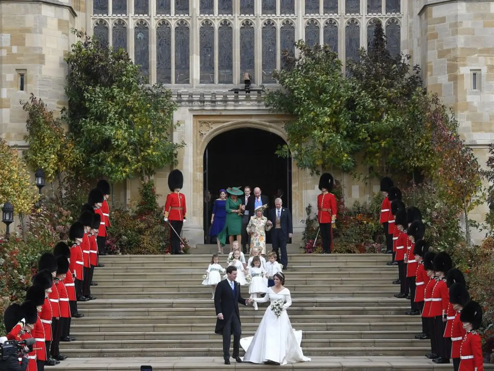 Britain's Princess Eugenie of York and her husband Jack Brooksbank leave after their wedding ceremony at St Georgeâs Chapel, Windsor Castle, near London, England, Friday Oct. 12, 2018. (Toby Melville, Pool via AP)