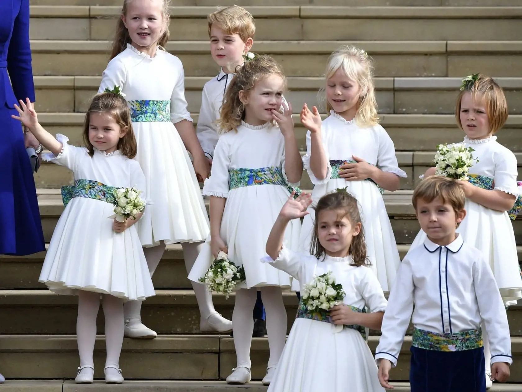 Bridesmaids and page boys, including Prince George, center, and Princess Charlotte, left, wave as they leave after the wedding ceremony of Princess Eugenie of York and Jack Brooksbank at St Georgeâs Chapel, Windsor Castle, near London, England, Friday Oct. 12, 2018. (Toby Melville, Pool via AP)