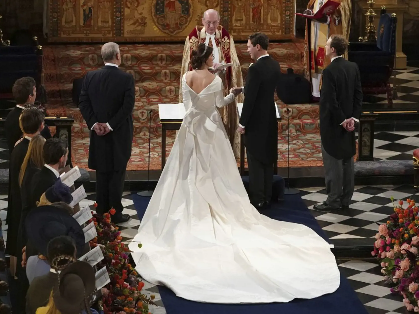 Princess Eugenie of York and Jack Brooksbank hold hands during their wedding in St Georgeâs Chapel, Windsor Castle, near London, England, Friday Oct. 12, 2018. (Owen Humphreys, Pool via AP)