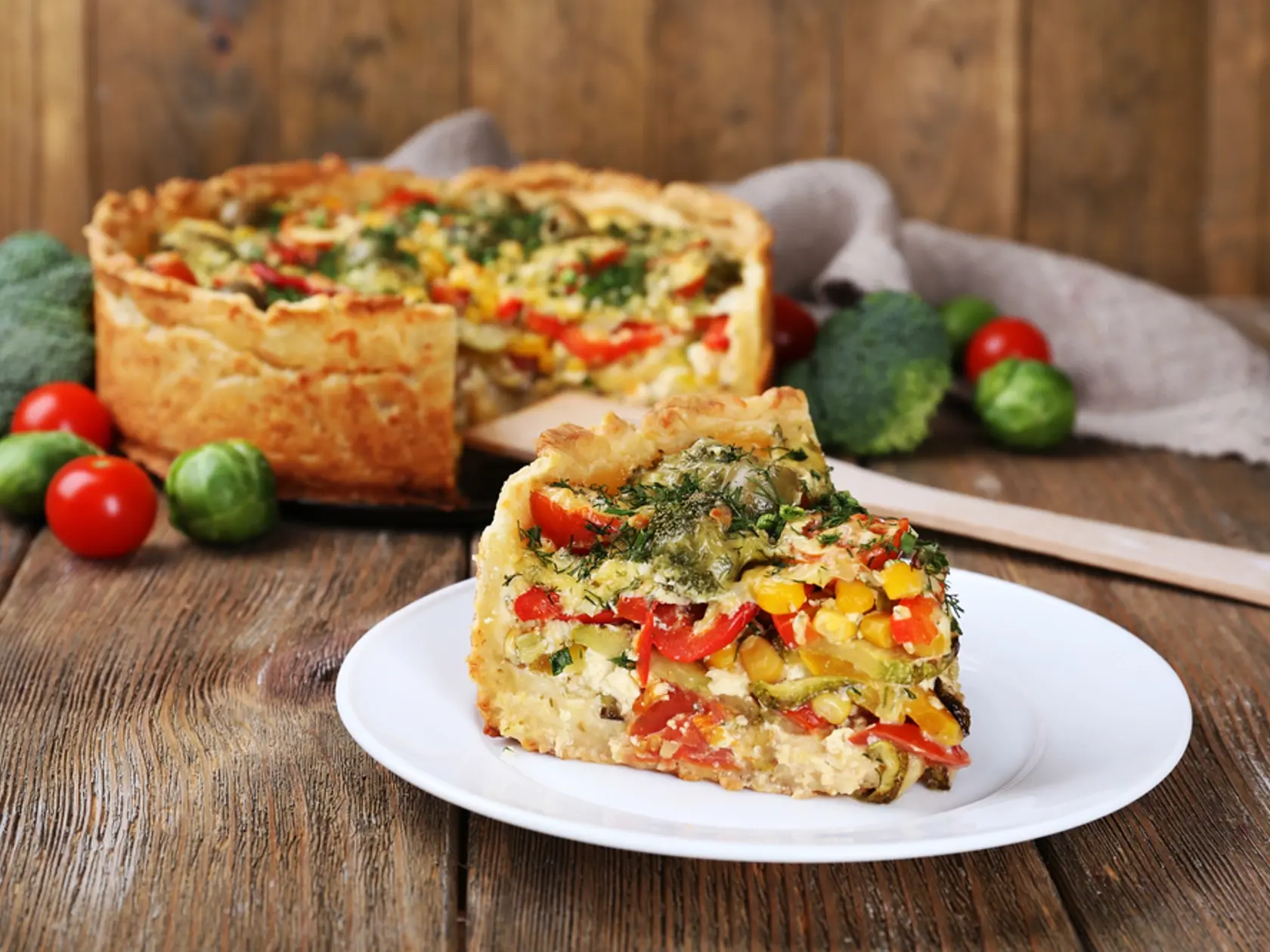 Piece,Of,Vegetable,Pie,With,Broccoli,,Peas,,Tomatoes,And,Cheese
