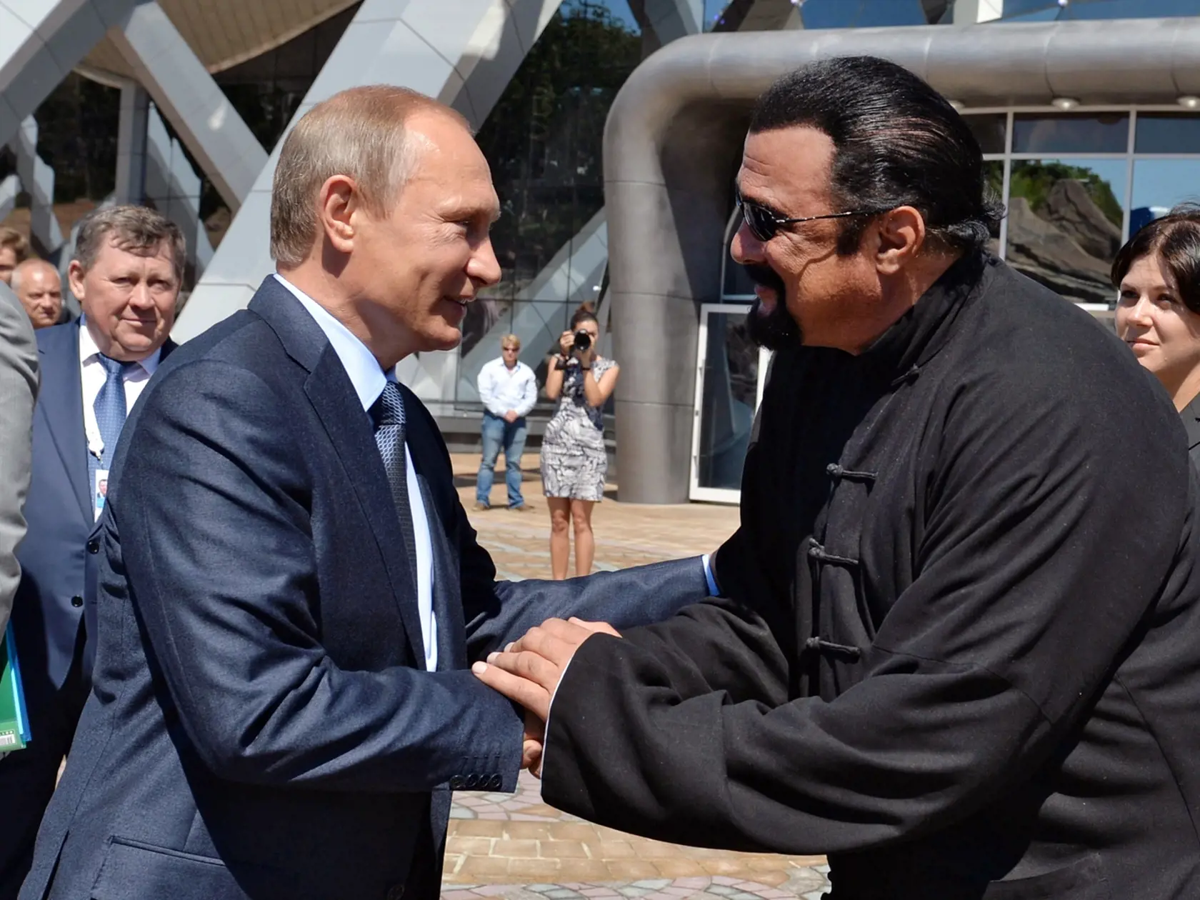 FILE - In this Sept. 4, 2015 file photo, Russian President Vladimir Putin, left, and U.S. actor Steven Seagal shake hands after visiting an oceanarium built on Russky Island, in the Russian Far Eastern port of Vladivostok. Putin's spokesman, Dmitry Peskov, told reporters on Thursday, Nov. 3, 2016, that Russia has awarded Russian citizenship to Seagal. (AP Photo/Alexei Druzhinin/Sputnik, Government Press Service Pool Photo via AP, File)