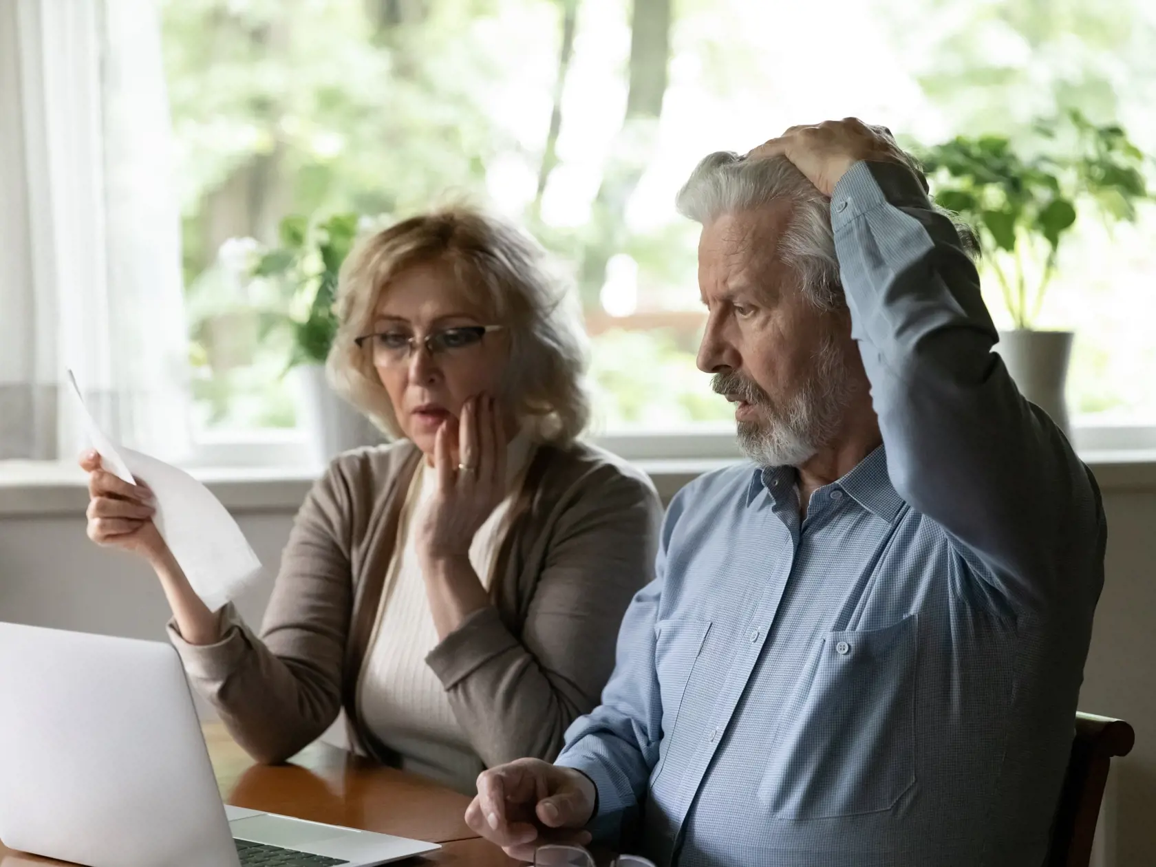 Unhappy,Shocked,Mature,Man,And,Woman,Reading,Documents,,Loan,Agreement,