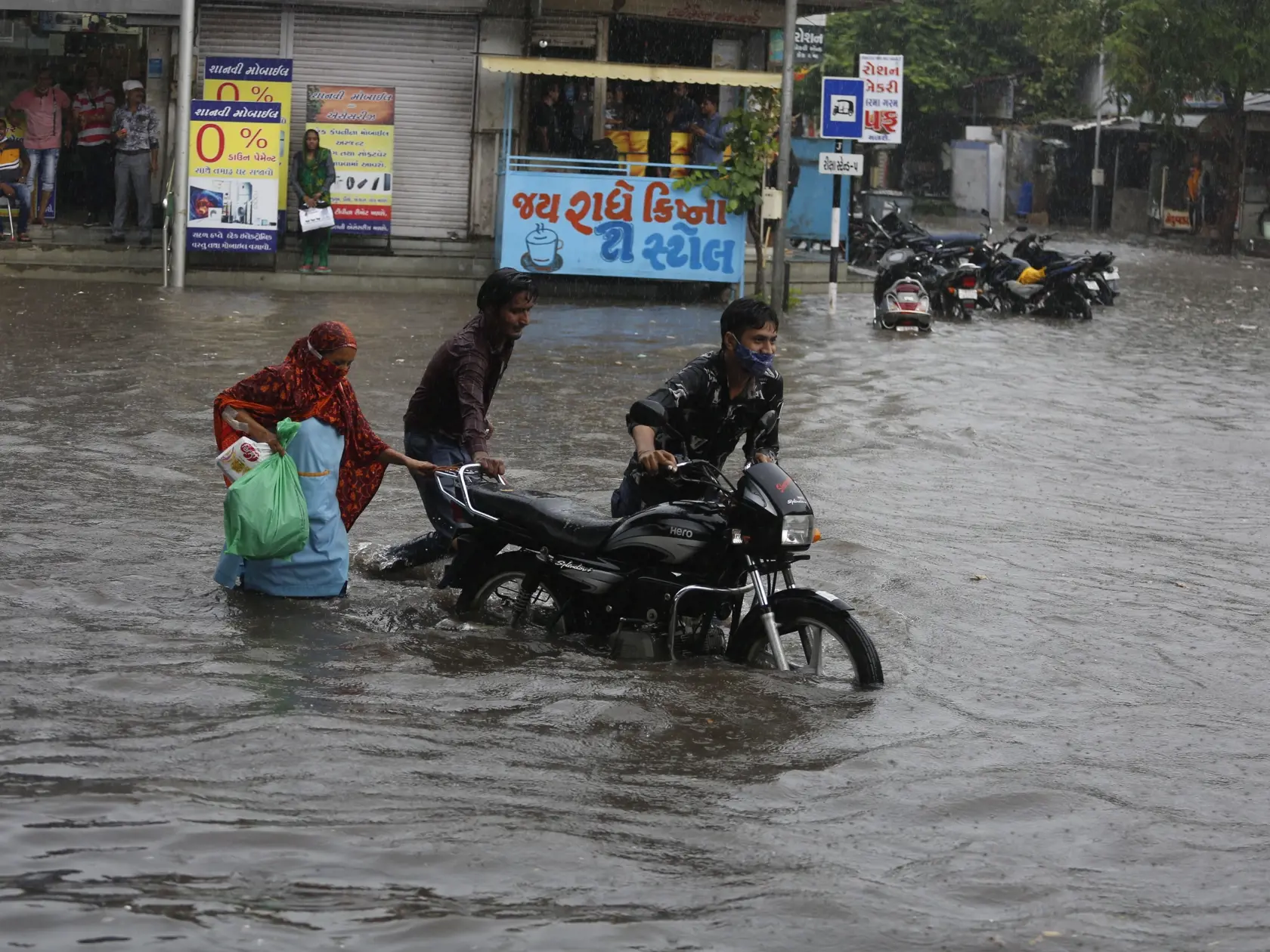 JB 16 Ahmedabád - Ľudia tlačia motocykel po zaplavenej ceste počas monzúnového dažďa v indickom meste Ahmedabád 22. júna 2021. FOTO TASR/AP

People push a motorcycle past a flooded road during rainfall in Ahmedabad, India, Tuesday, June 22, 2021. (AP Photo/Ajit Solanki)