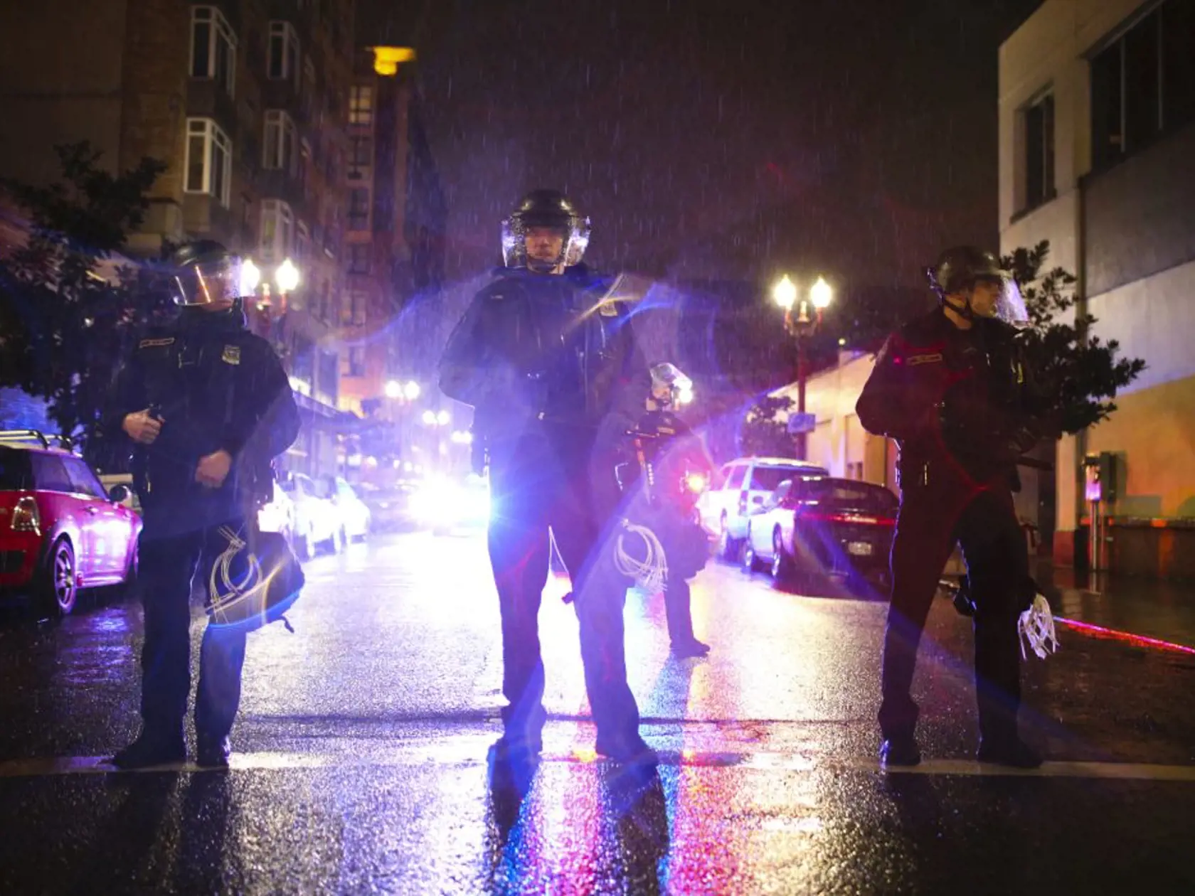 A crowd marches in protest through the streets of Portland, Ore., following Donald Trump's presidential inauguration, Friday, Jan. 20, 2017.  Police in Portland used incendiary devices and tear gas to disperse a crowd of people protesting President Donald Trump. Authorities said some people in the crowd - that at one point numbered in the thousands - threw rocks, bottles, flares and "unknown liquid" at officers Friday night.   (Stephanie Yao Long/The Oregonian via AP)