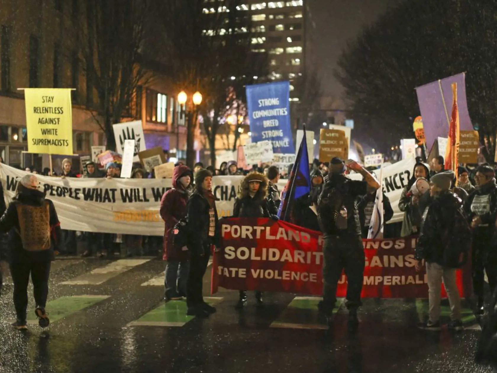A crowd marches in protest through the streets of Portland, Ore., following Donald Trump's presidential inauguration, Friday, Jan. 20, 2017.  (Dave Killen/The Oregonian via AP)