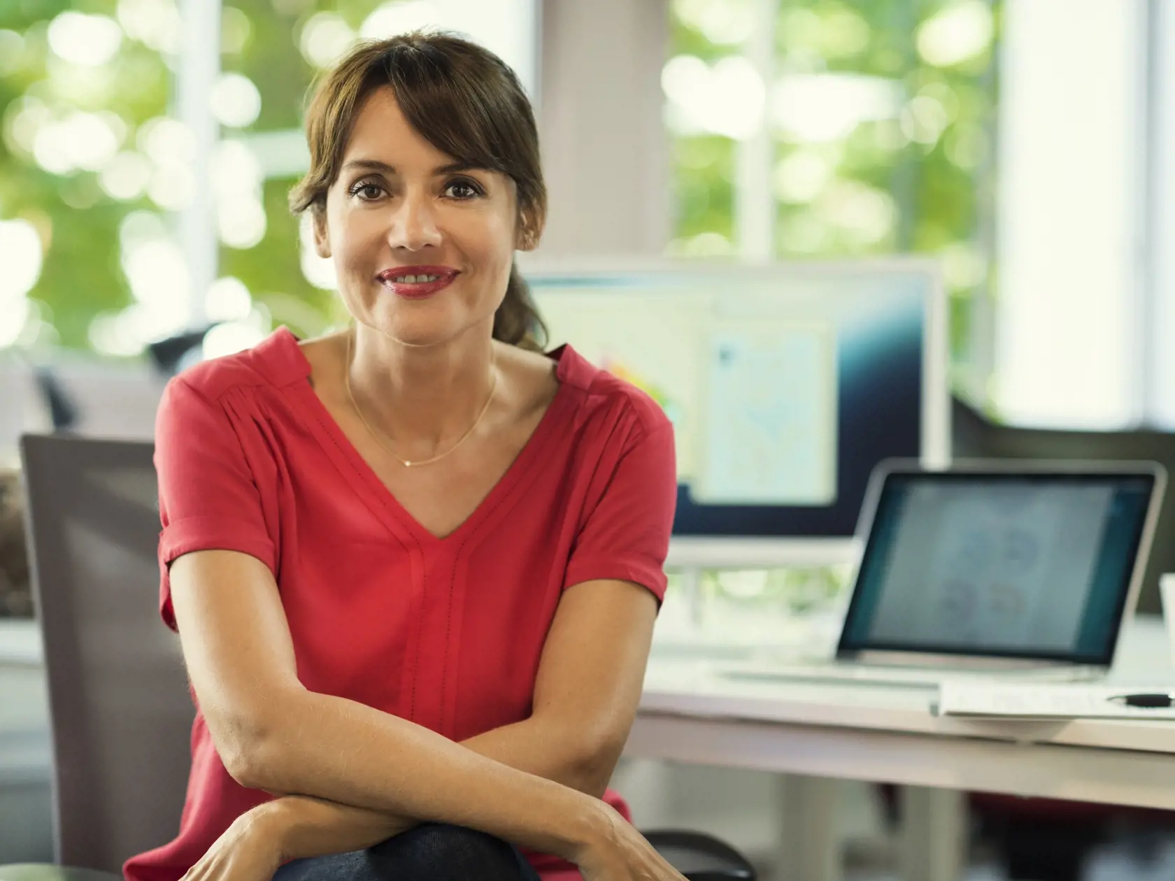 Portrait of mature business woman manager in her desk