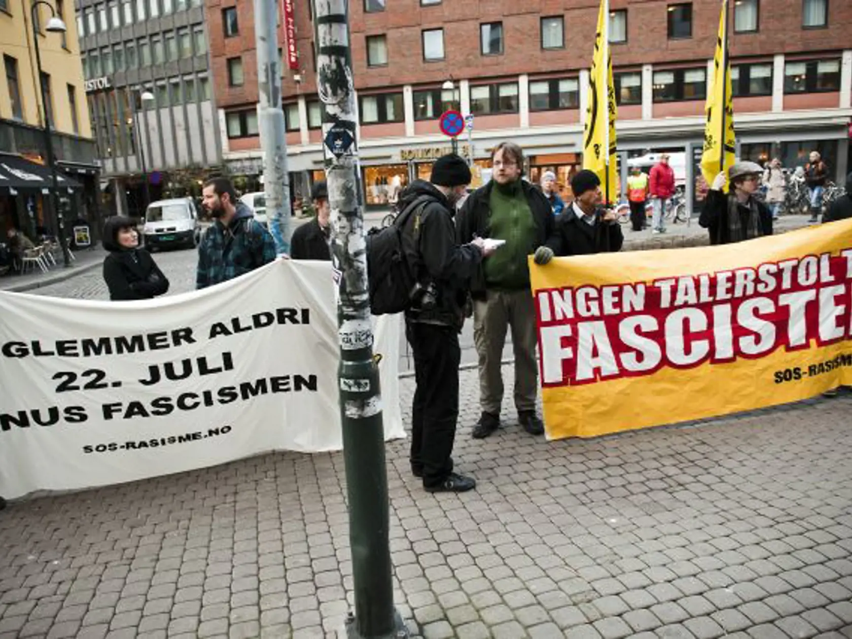 Demonstrators stand outside the courthouse in Oslo Monday morning Nov. 14, 2011. In anticipation of the hearing for Anders Behring Breivik they brandish posters translating to "We will never forget the 22nd. July massacre, crush fascism" and "No podium for fascists". Breivik has admitted killing 77 people on July 22. (AP Photo/Scanpix, Fredrik Varfjell)  NORWAY OUT