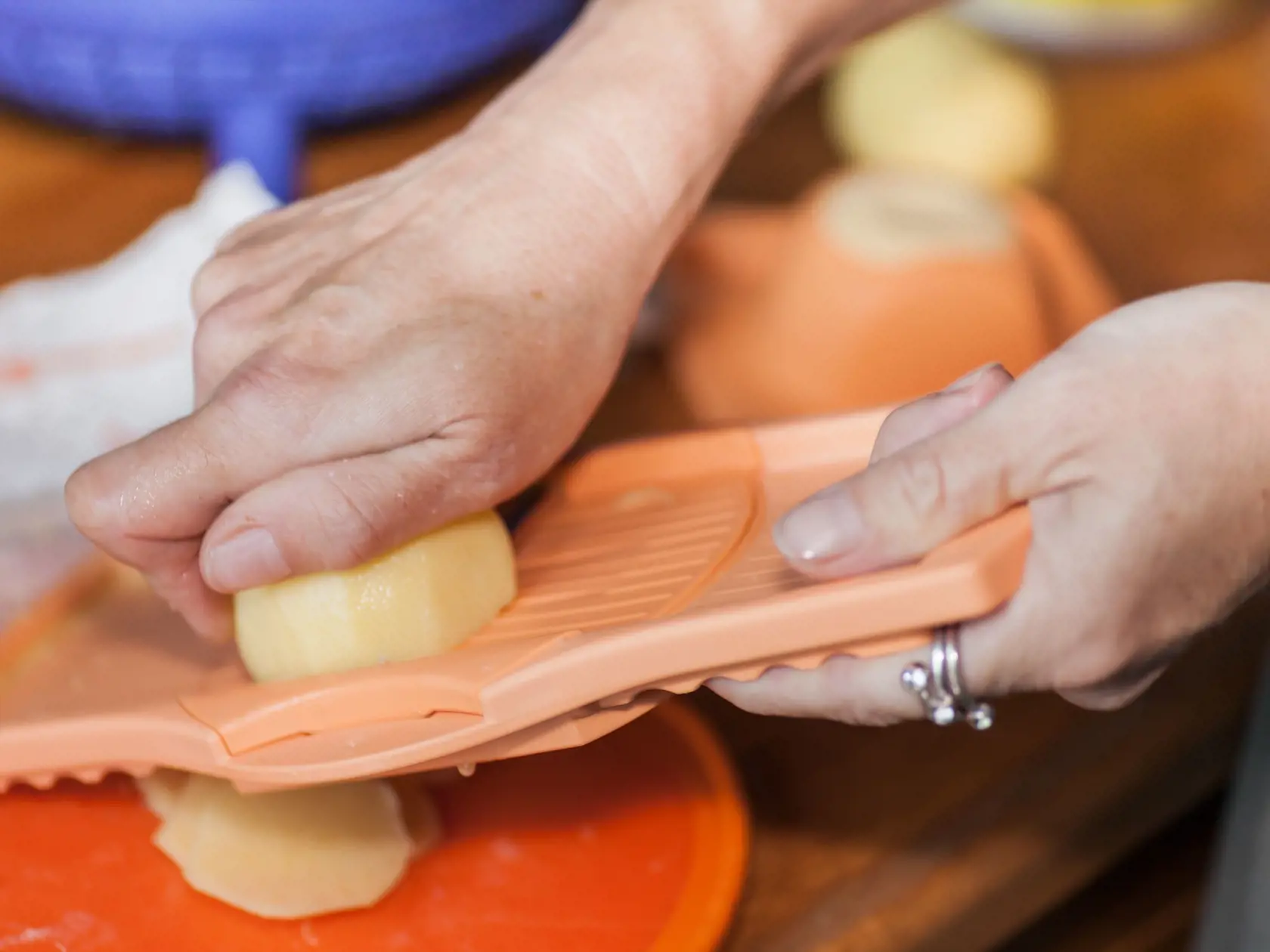 Woman hand working on a potato grater