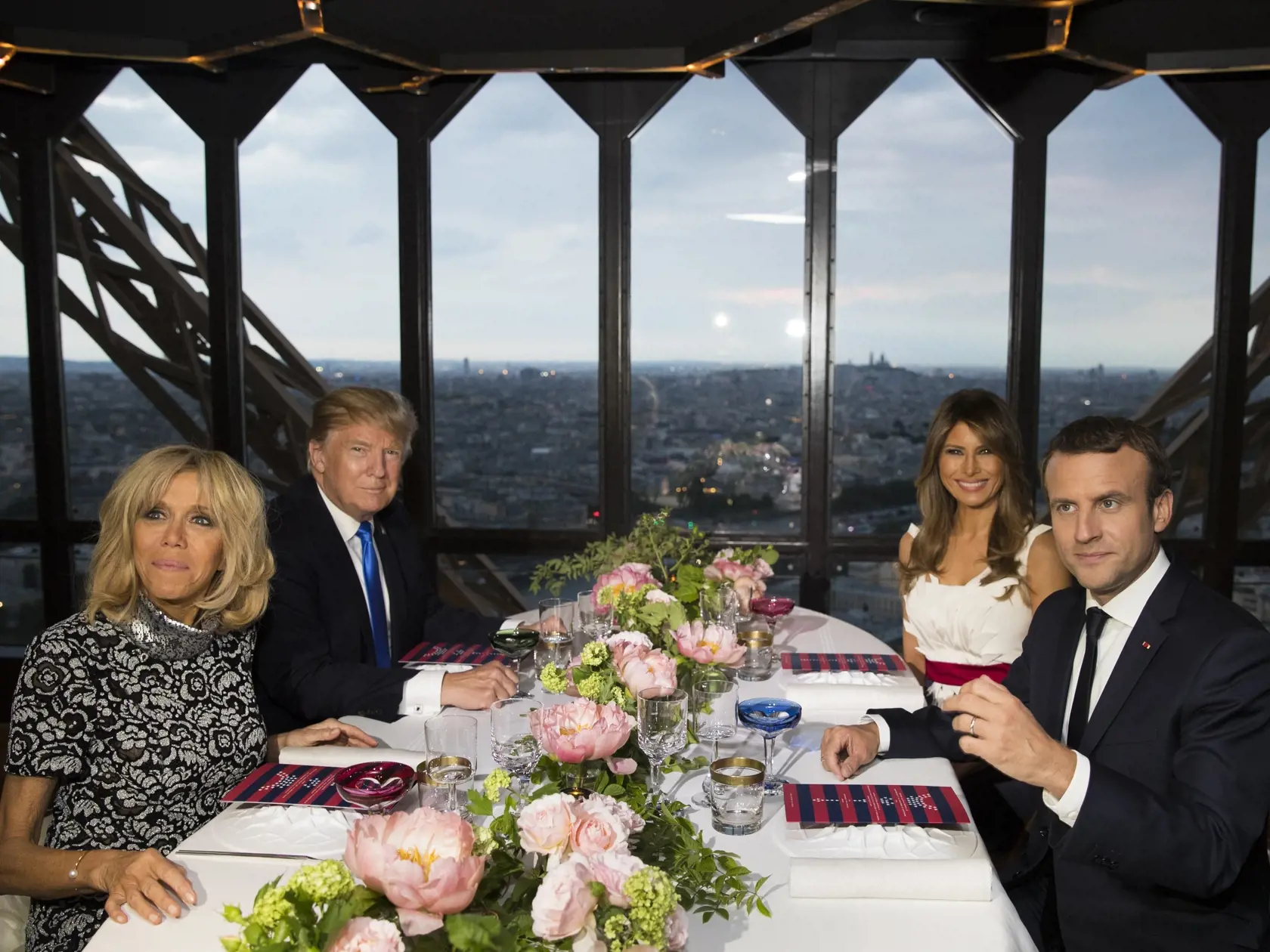 President Donald Trump, first lady Melania Trump, French President Emmanuel Macron his wife Brigitte Macron, sit for dinner at the Jules Verne Restaurant on the Eiffel Tower in Paris, Thursday, July 13, 2017. (AP Photo/Carolyn Kaster)