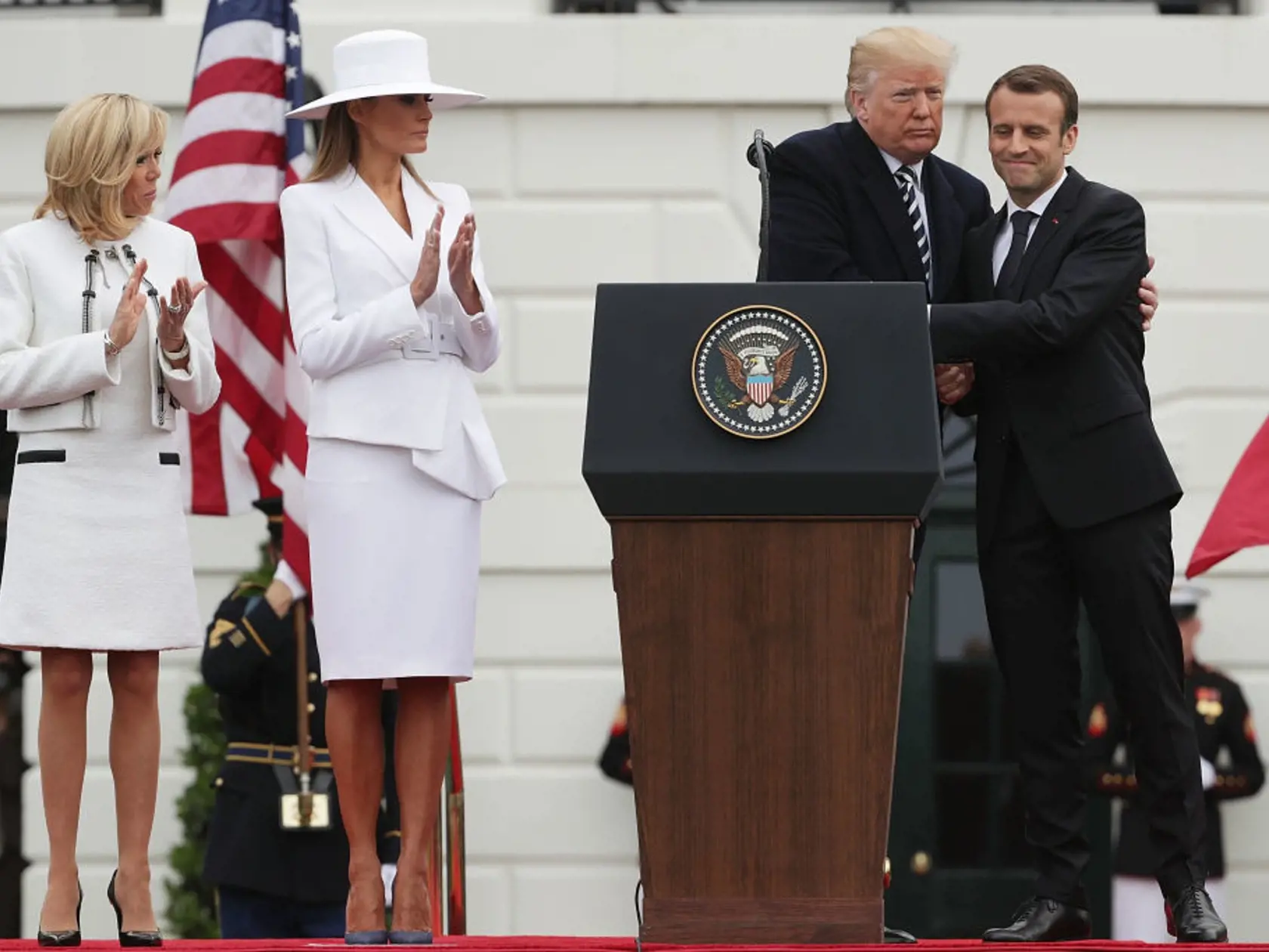 WASHINGTON, DC - APRIL 24:  U.S. President Donald Trump (3rd L) and French President Emmanuel Macron (R) hug each other as U.S. first lady Melania Trump (2nd L) and French first lady Brigitte Macron (L) look on during a state arrival ceremony at the South Lawn of the White House April 24, 2018 in Washington, DC. Trump is hosting Macron for a two-day official visit that includes dinner at George Washington's Mount Vernon, a tree planting on the White House South Lawn, an Oval Office meeting, a jo