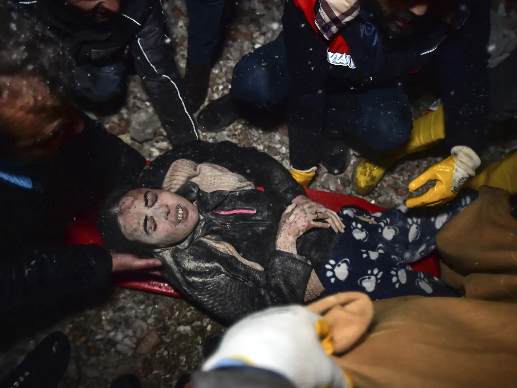 WA 50 Elbistan - Záchranári odnášajú ženu, ktorú našli medzi troskami budovy zrútenej v dôsledku zemetrasenia v meste Elbistan na juhu Turecka v utorok 7. februára 2023.