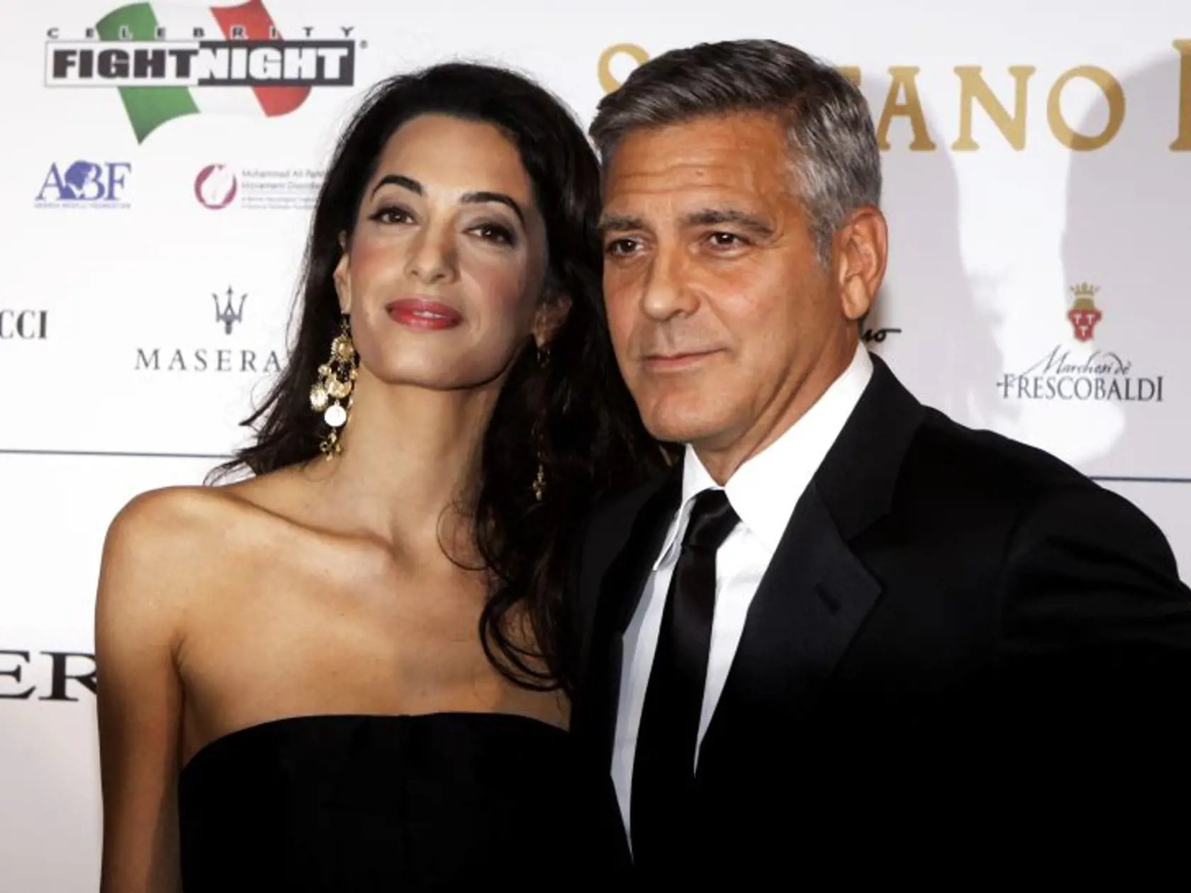 George Clooney and his fiancee Amal Alamuddin pose for photographers as they arrive for the "Celebrity Fight Night" foundation gala dinner, in Florence, Italy, Sunday, Sept. 7, 2014. (AP Photo/Francesco Bellini)