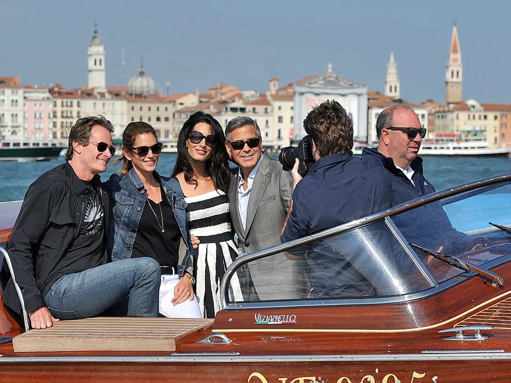 George Clooney, third right, his fiancee Amal Alamuddin, Cindy Crawford and her husband Rande Gerber cruise past St. Mark's Square as they arrive in Venice, Italy, Friday, Sept. 26, 2014. Clooney, 53, and Alamuddin, 36, are expected to get married this weekend in Venice, one of the world's most romantic settings. (AP Photo/Luigi Costantini)