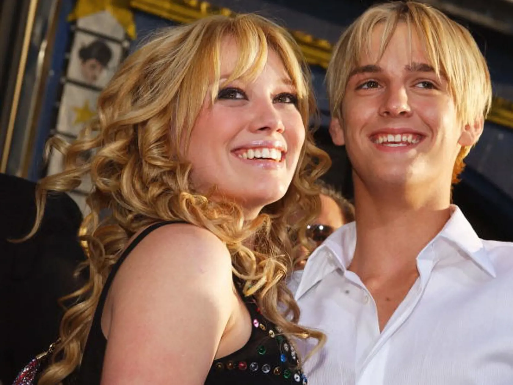 HOLLYWOOD, CA - APRIL 26: Actress Hilary Duff (L) hugs singer Aaron Carter as they attend the premiere of The Lizzie McGuire Movie on April 26, 2003 in Hollywood, California. (Photo by Lucy Nicholson/Getty Images)