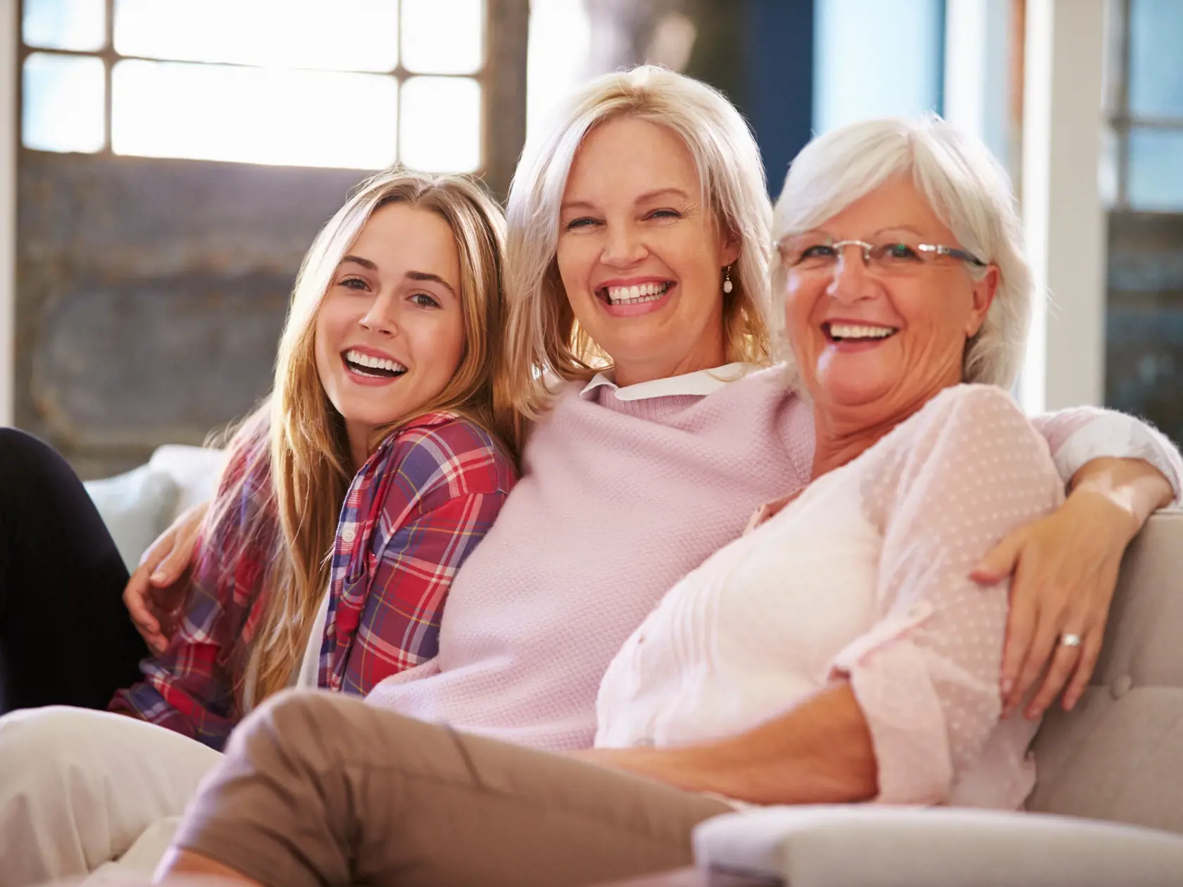 Grandmother,With,Mother,And,Adult,Daughter,Relaxing,On,Sofa