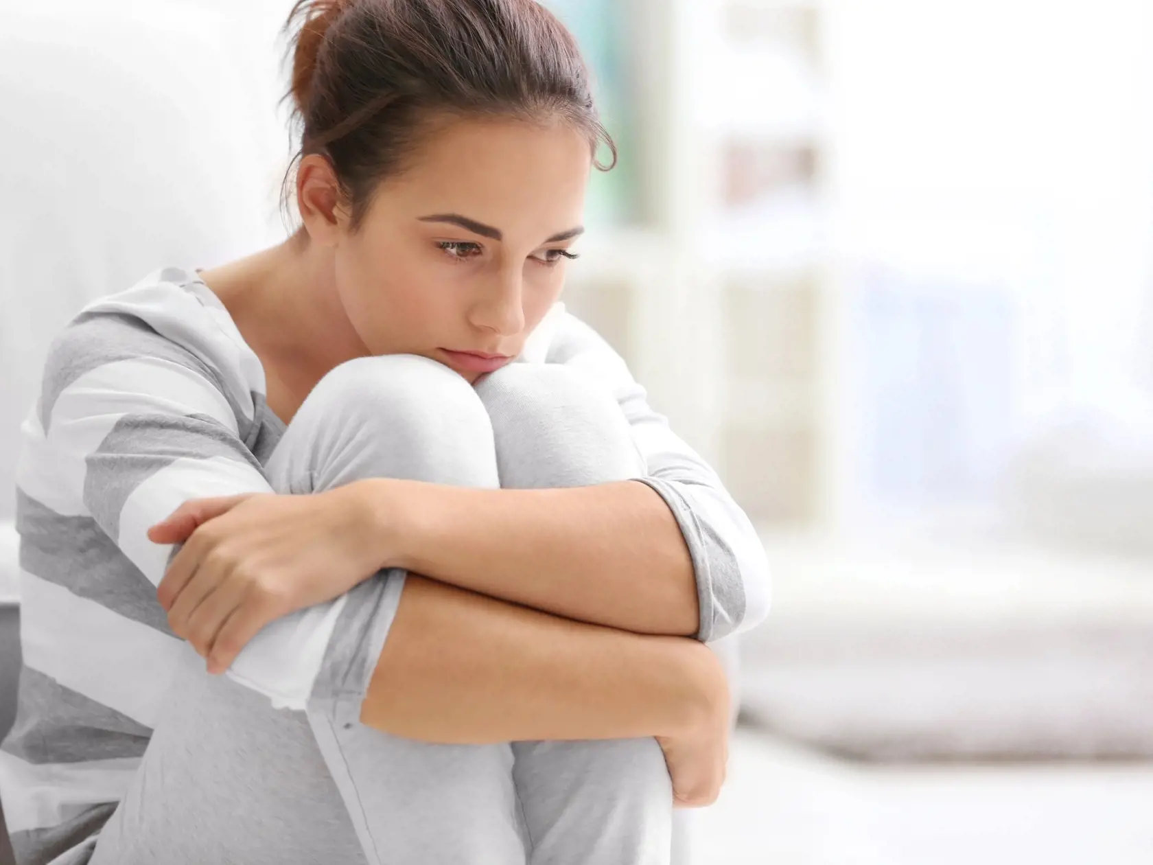 Depressed,Young,Woman,Sitting,On,Floor,At,Home