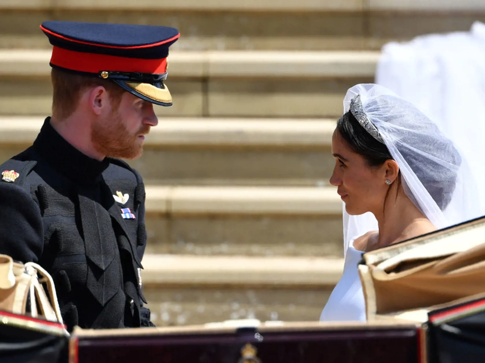 WINDSOR, UNITED KINGDOM - MAY 19: Prince Harry, Duke of Sussex and the Duchess of Sussex get into the Ascot Landau Carriage after their wedding ceremony at St George's Chapel, Windsor Castle on May 19, 2018 in Windsor, England. (Photo by  Ben STANSALL - WPA Pool/Getty Images)