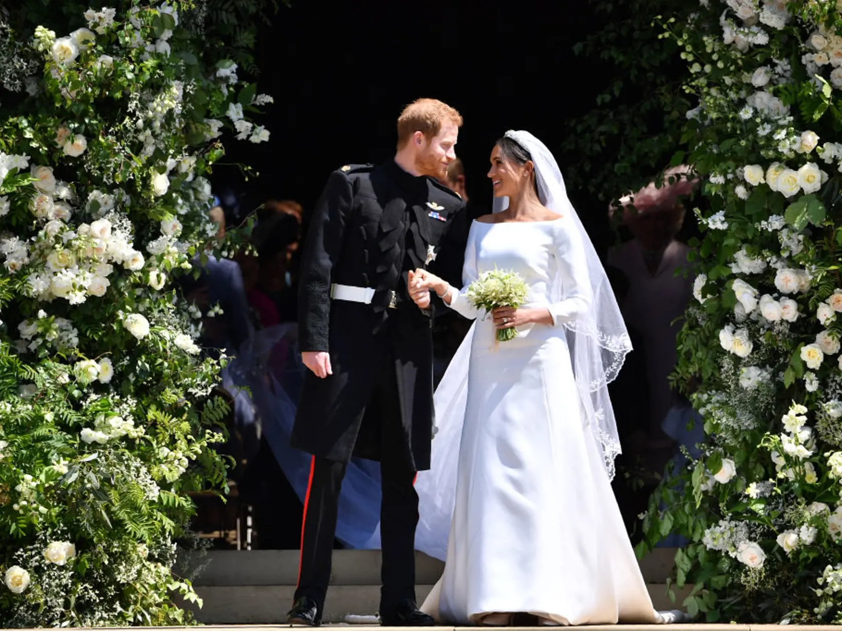 WINDSOR, UNITED KINGDOM - MAY 19: Britain's Prince Harry, Duke of Sussex and his wife Meghan, Duchess of Sussex leave from the West Door of St George's Chapel, Windsor Castle, in Windsor on May 19, 2018 in Windsor, England. (Photo by  Ben STANSALL - WPA Pool/Getty Images)