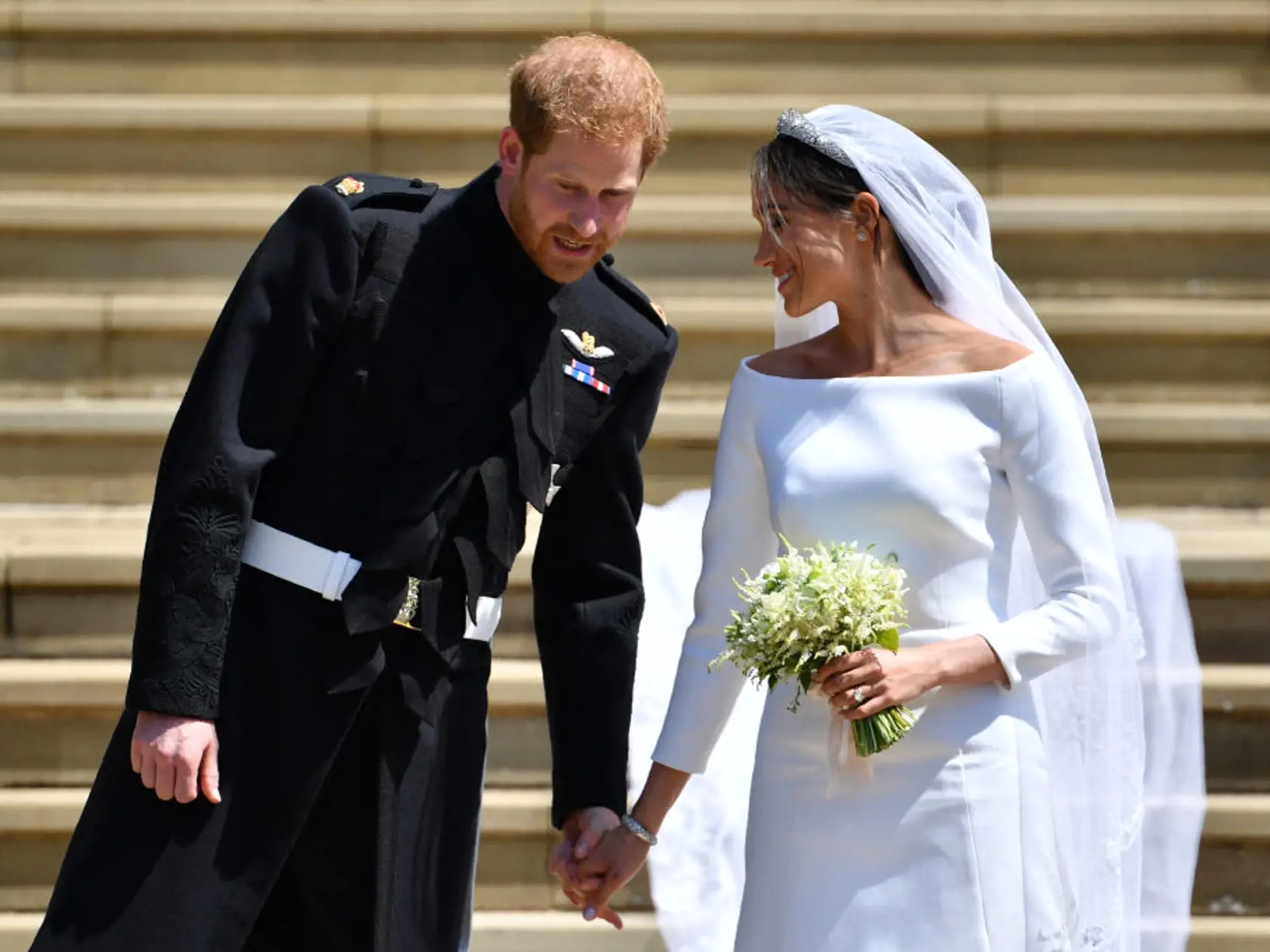 WINDSOR, UNITED KINGDOM - MAY 19: Britain's Prince Harry, Duke of Sussex and his wife Meghan, Duchess of Sussex leave from the West Door of St George's Chapel, Windsor Castle, in Windsor on May 19, 2018 in Windsor, England. (Photo by  Ben STANSALL - WPA Pool/Getty Images)