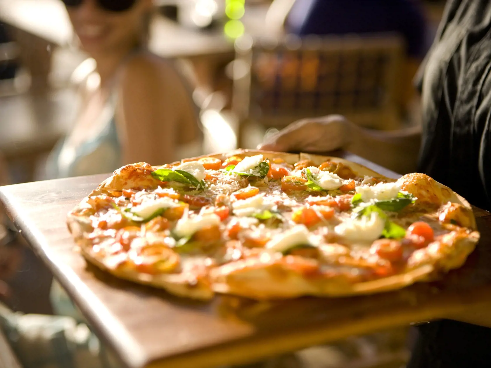 Serving pizza