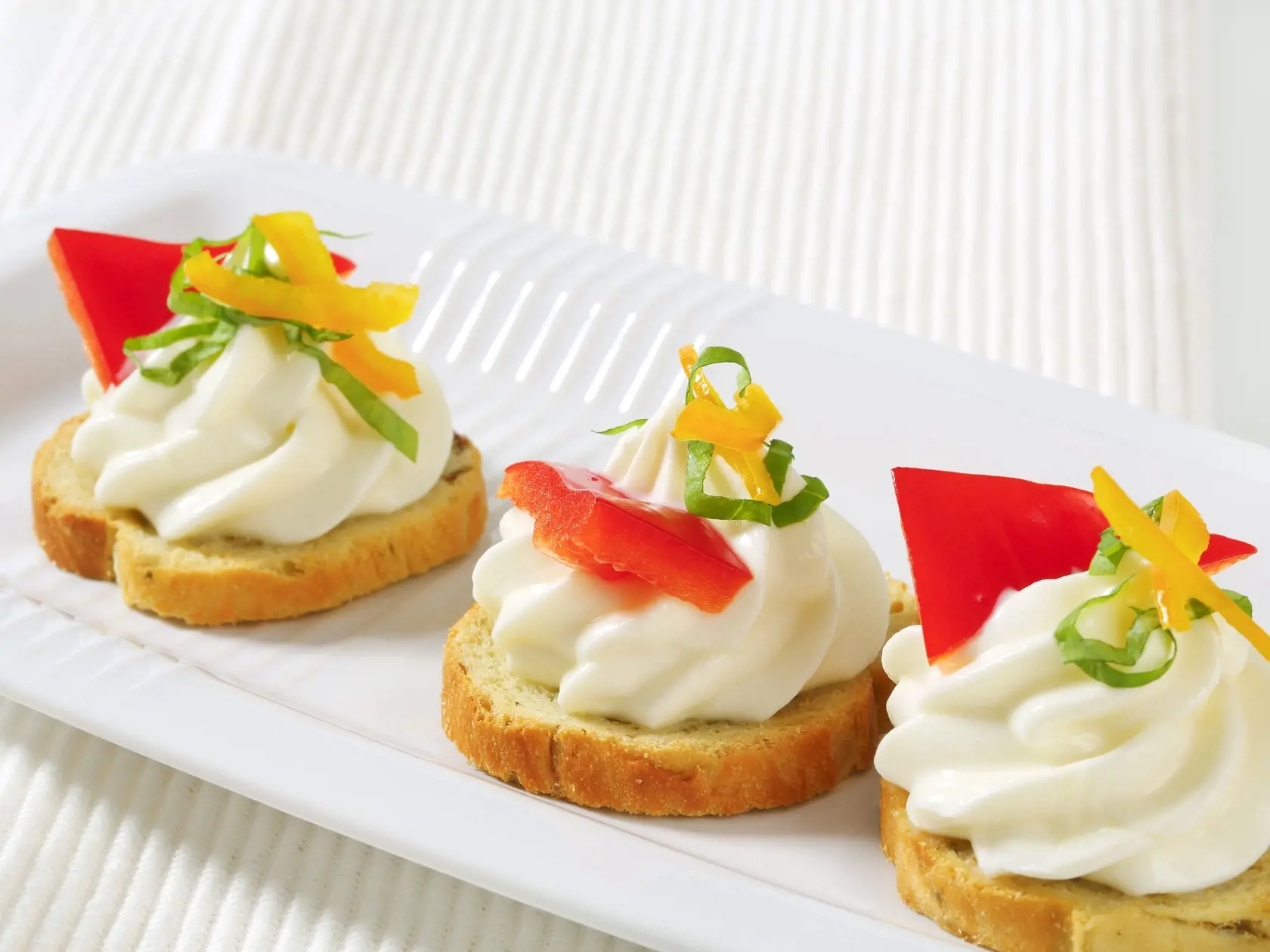 Small round toasts with cheese spread