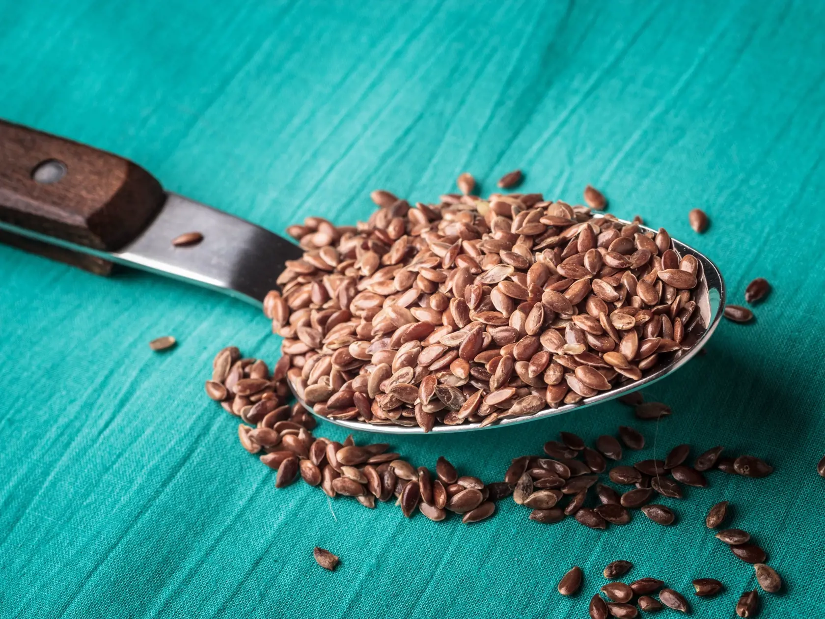 Flax seeds linseed on kitchen spoon