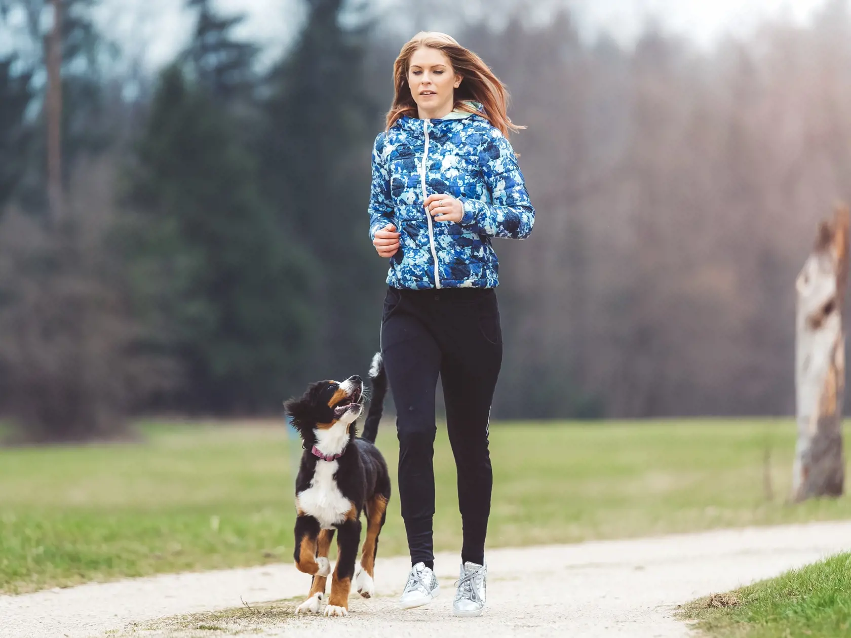 Young woman jogging with dog