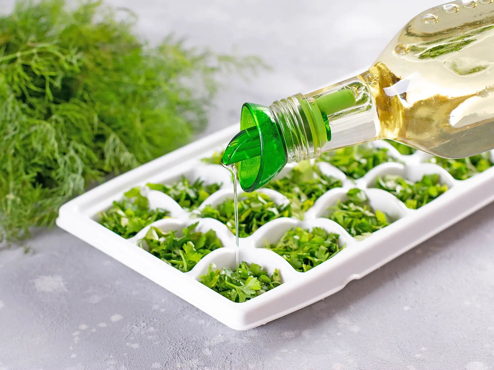 Frozen Herb Butter In White tray, Olive Oil With herbs on light background.