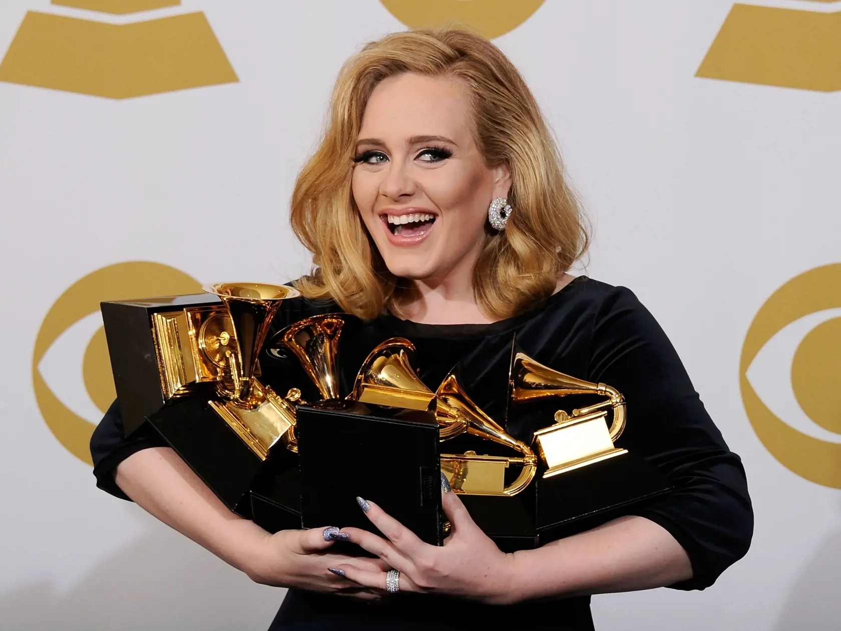 LOS ANGELES, CA - FEBRUARY 12:  Singer Adele, winner of the GRAMMYs for Record of the Year for "Rolling In The Deep", Album of the Year for "21", Song of the Year for "Rolling In The Deep", Best Pop Solo Performance for "Someone Like You", Best Pop Vocal Album for "21" and Best Short Form Music Video for "Rolling In The Deep", poses in the press room at the 54th Annual GRAMMY Awards at Staples Center on February 12, 2012 in Los Angeles, California.  (Photo by Kevork Djansezian/Getty Images)
