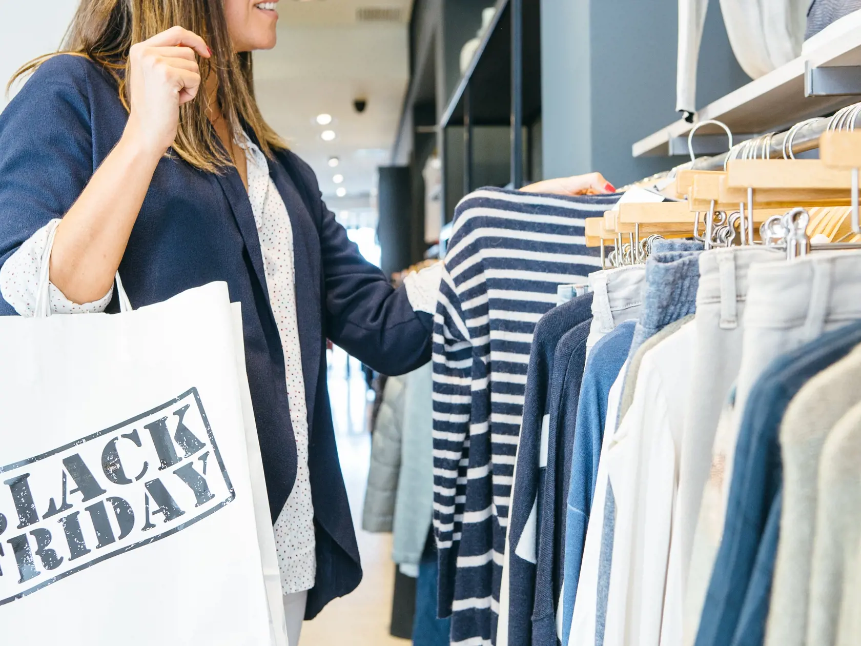 Side,View,Of,A,Woman,Looking,Through,Clothing,Rack,And