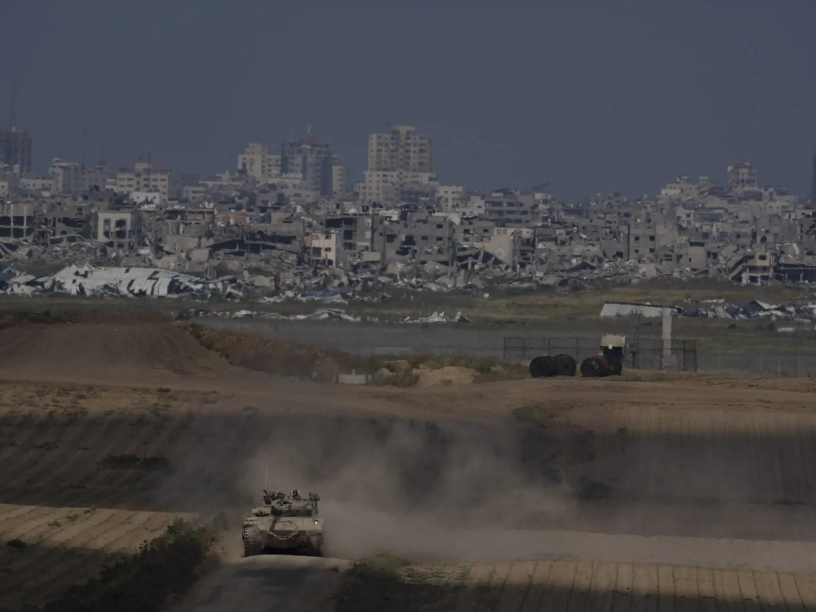 Izraelskí vojaci sa presúvajú na tanku neďaleko hranice Izraela s pásmom Gazy, čo je viditeľné z juhu Izraela 9. apríla 2024. Izraelská armáda bojuje s palestínskymi militantmi hnutia Hamas v pásme Gazy po útokoch Hamasu na Izrael 7. októbra.