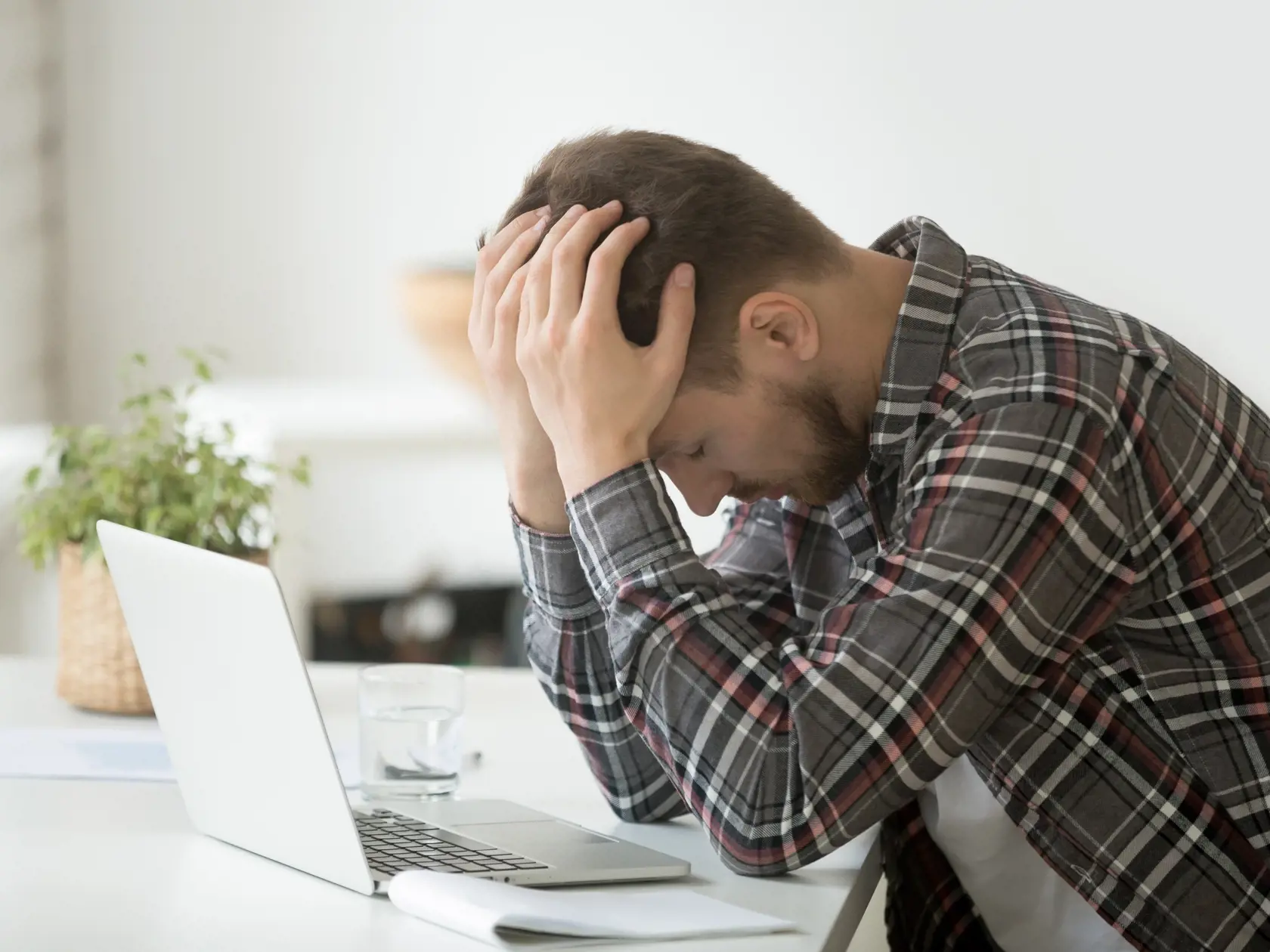 Frustrated,Depressed,Man,Holding,Head,In,Hands,Shocked,By,Bankruptcy