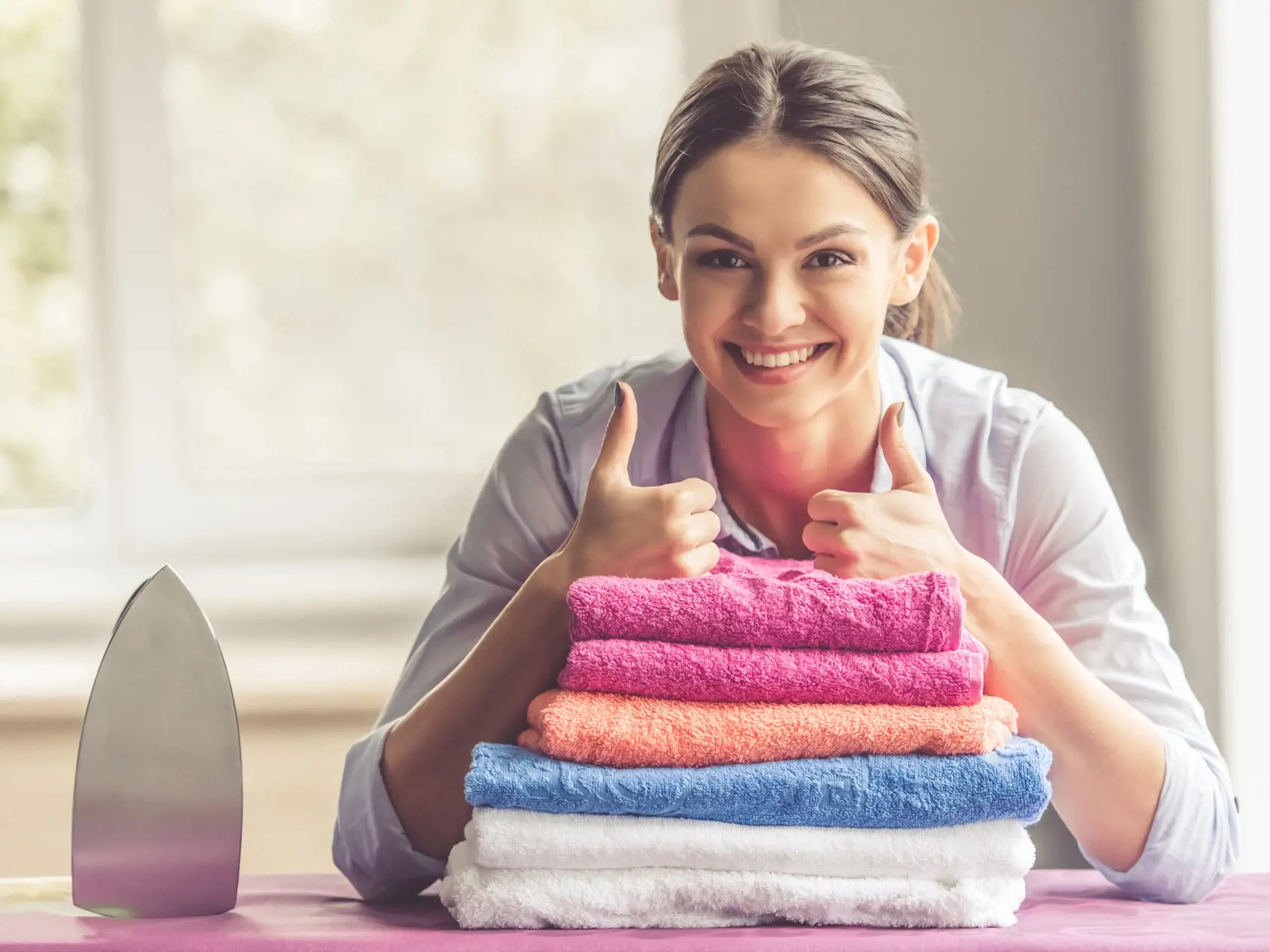 Beautiful,Young,Woman,Is,Leaning,On,Ironing,Board,,Showing,Ok