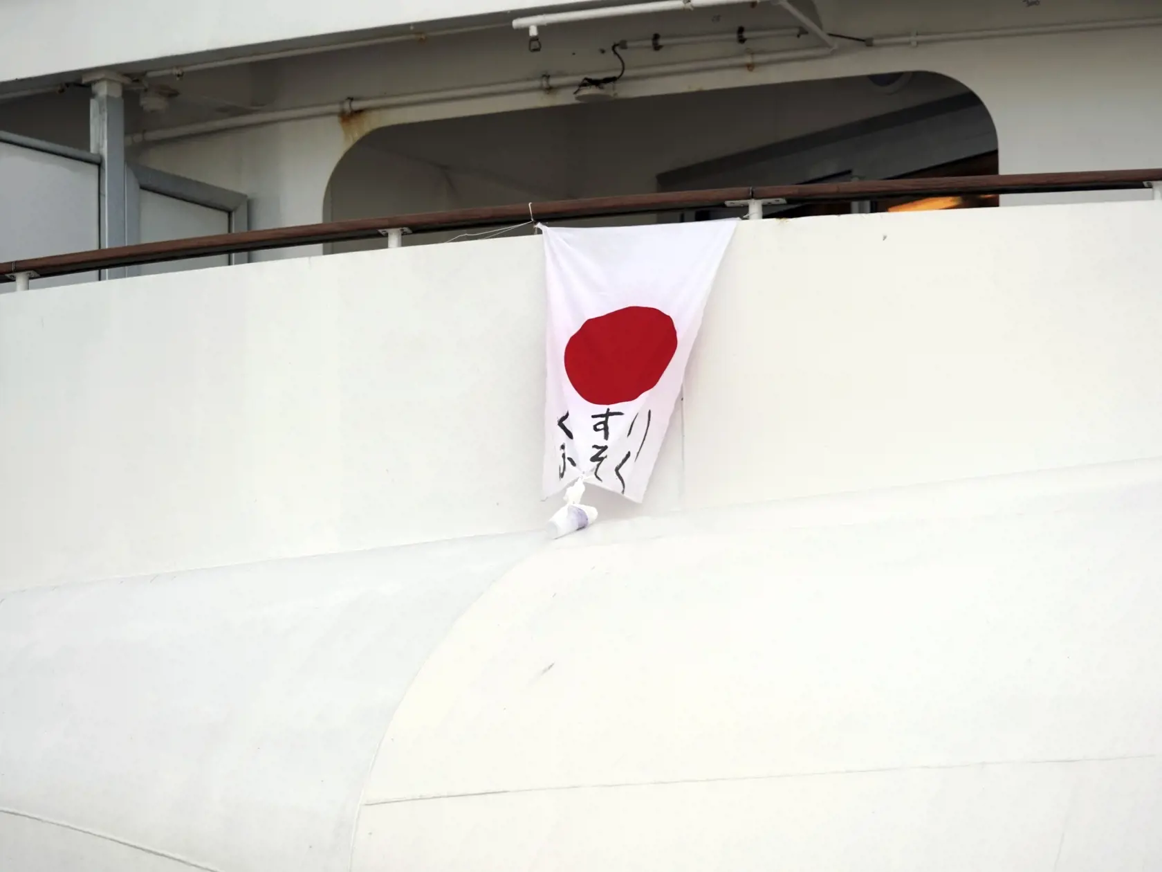 KK10 Jokohama - Na snímke japonská zástava s odkazom "Nedostatok liekov" na výletnej lodi Diamond Princess, ktorá kotví v prístave v Jokohame 7. februára 2020. Ďalších 41 prípadov nákazy novým koronavírusom potvrdili lekárske testy pasažierov výletnej lode, ktorá sa momentálne nachádza v karanténe pri pobreží Japonska. Doterajší počet nakazených na plavidle Diamond Princess sa tak zvýšil na 61. FOTO TASR/AP
A japanese flag with a message reading "Lack of medicine" hangs from the cruise ship Diam