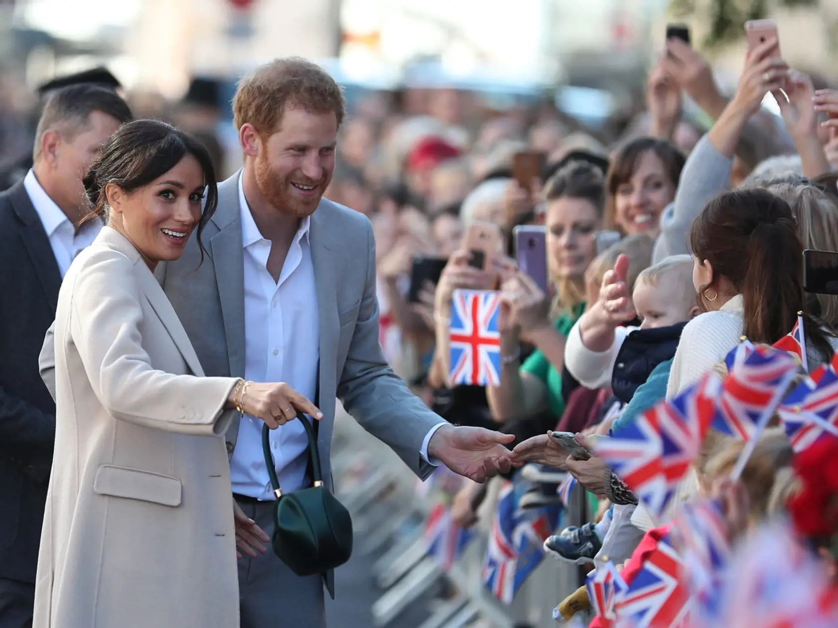 CHICHESTER, ENGLAND - OCTOBER 3: Meghan, Duchess of Sussex and Prince Harry, Duke of Sussex greet well-wishers as they arrive for an engagement at Edes House during an official visit to Sussex on October 3, 2018 in Chichester, England. The Duke and Duchess married on May 19th 2018 in Windsor and were conferred The Duke & Duchess of Sussex by The Queen.  (Photo by Daniel Leal-Olivas - WPA Pool/Getty Images)