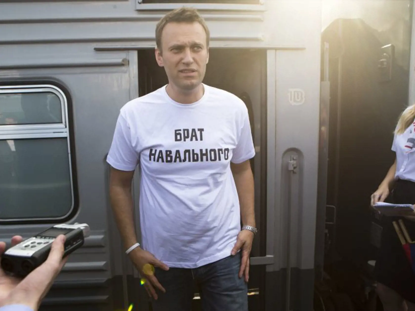 Russian opposition activist Alexei Navalny, wearing a T-shirt reading "Navalny's Brother" speaks to supporters and the media at the Yaroslavsky railway terminal before a departure to the city of Kirov where a court is set to announce a verdict in his case on Thursday, in Moscow, Wednesday, July 17, 2013. Alexei Navalny's energy and charisma propelled him from a lonely role blogging about corruption to wide renown as Russia's leading opposition activist. His projects, including a campaign to run 