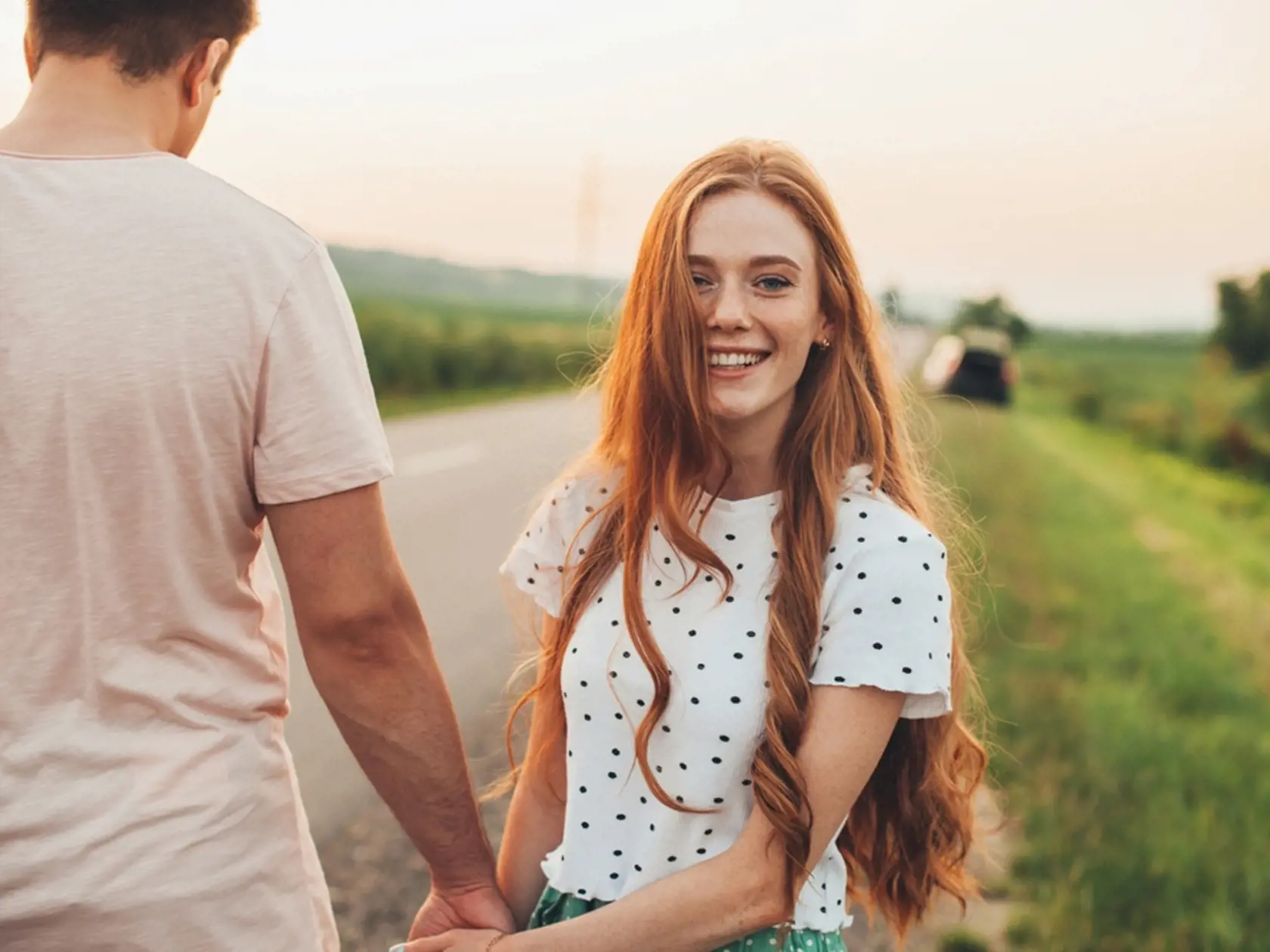 Shot,Of,A,Happy,Couple,Walking,Through,An,Country,Road.