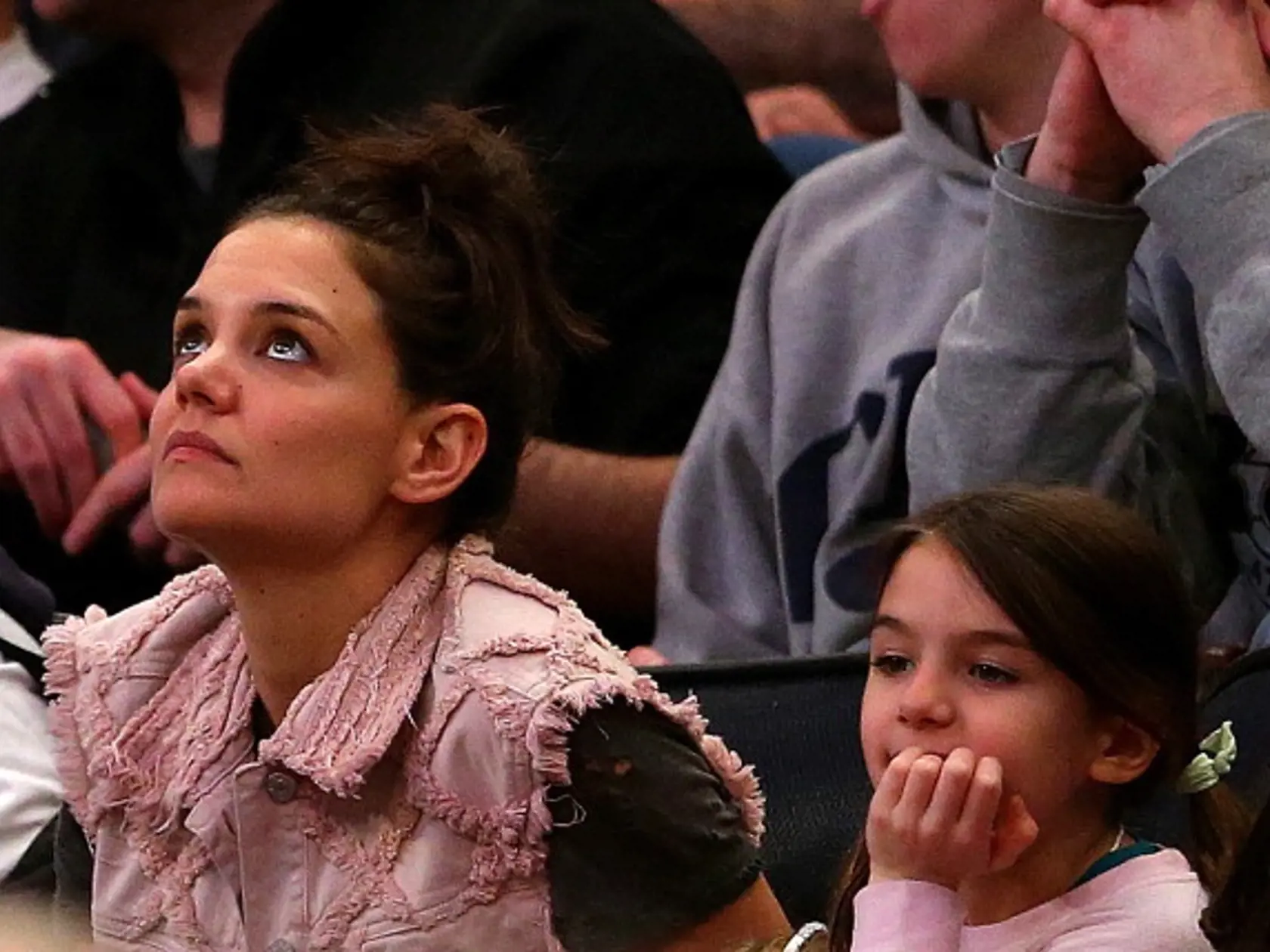 NEW YORK, NY - MARCH 30:  Actress Katie Holmes and her daughter Suri Cruise attend the East Regional Final of the 2014 NCAA Men's Basketball Tournament between the Connecticut Huskies and the Michigan State Spartans at Madison Square Garden on March 30, 2014 in New York City.  (Photo by Elsa/Getty Images)