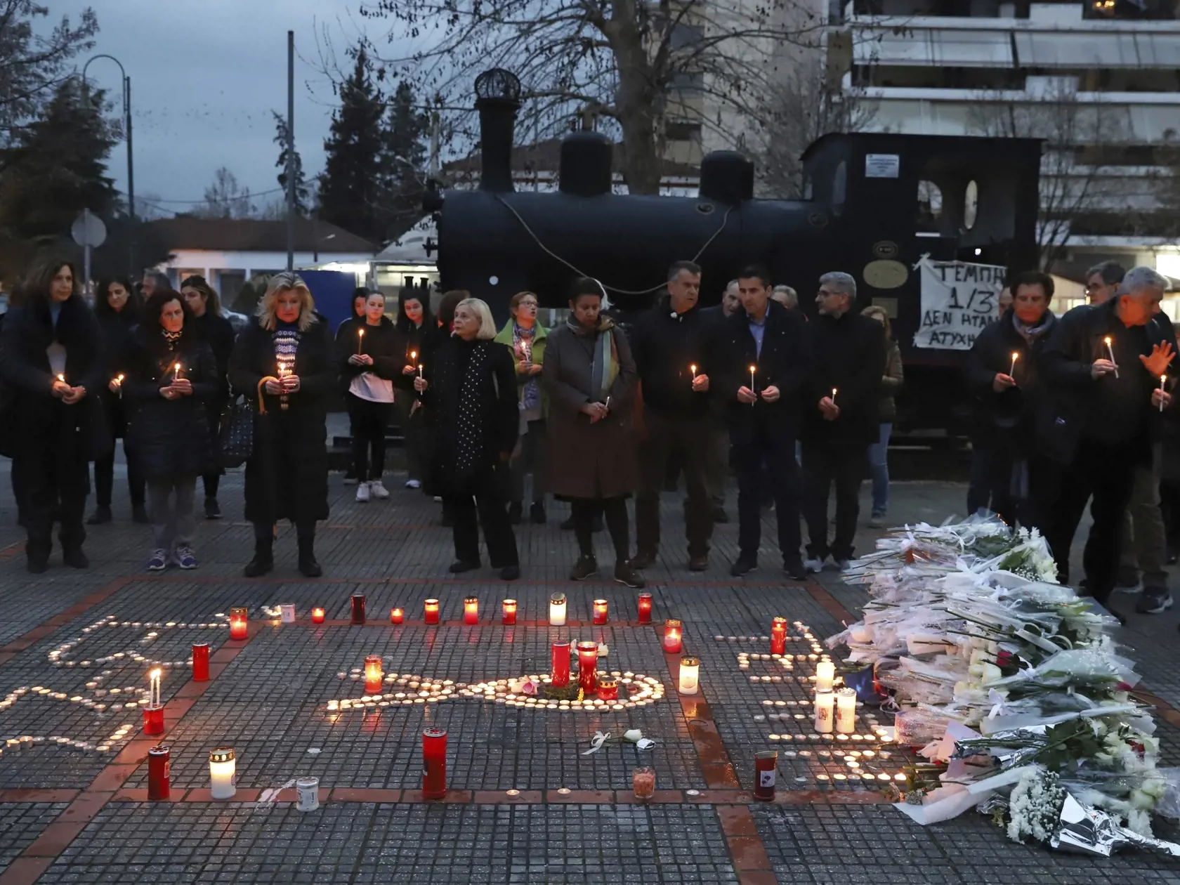JB 27 Atény - Ľudia držia sviečky na pamiatku obetí vlakovej tragédie počas protestu pred sídlom železničnej spoločnosti Hellenic Train v Aténach 2. marca 2023. Približne 700 ľudí sa vo štvrtok zhromaždilo pred sídlom železničnej spoločnosti Hellenic Train v Aténach, kde protestovali proti chronickým nedostatkom a zlyhaniam. Tie v utorok krátko pred polnocou spôsobili čelnú zrážku dvoch vlakov s 57 mŕtvymi. TASR prevzala správu z tlačovej agentúry AFP.    Protestujúci si minútou ticha uctili pam