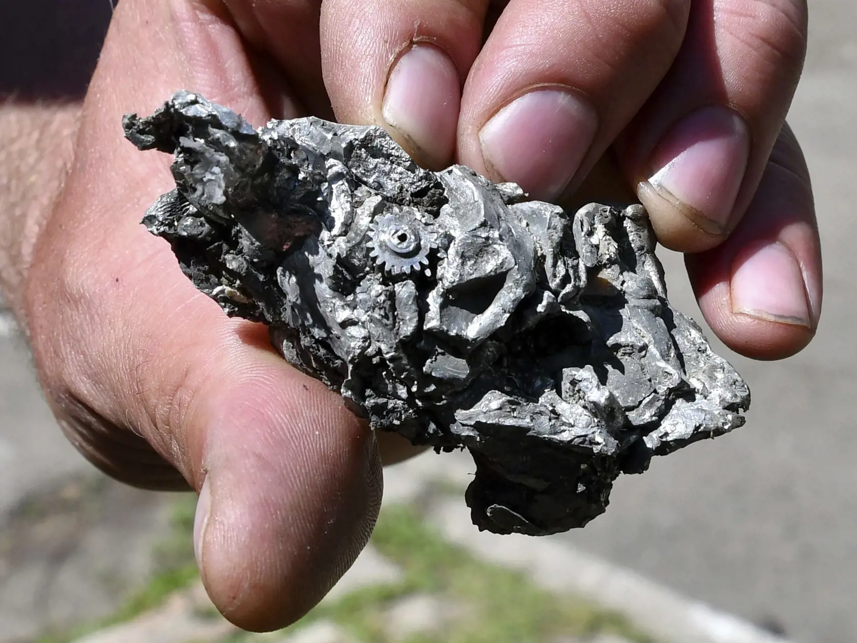 Muž ukazuje časť rakety, ktorú našli po ruskom ostreľovaní v obytnej zóne v meste Bachmut v Doneckej oblasti na východe Ukrajiny počas 78. dňa ruskej invázie na Ukrajinu vo štvrtok 12. mája 2022.