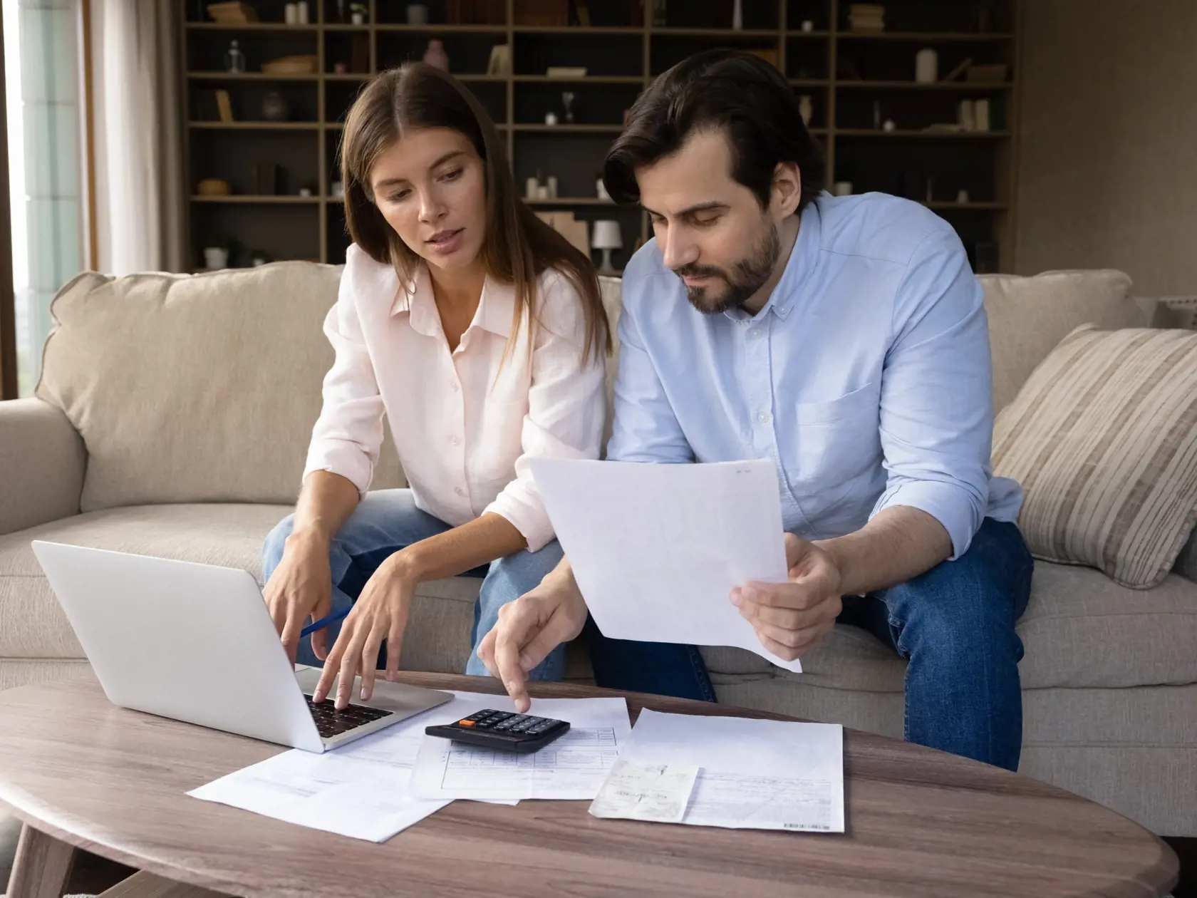 Concentrated,Young,Family,Couple,Calculating,Expenditures,,Analyzing,Paper,Bank,Bills,
