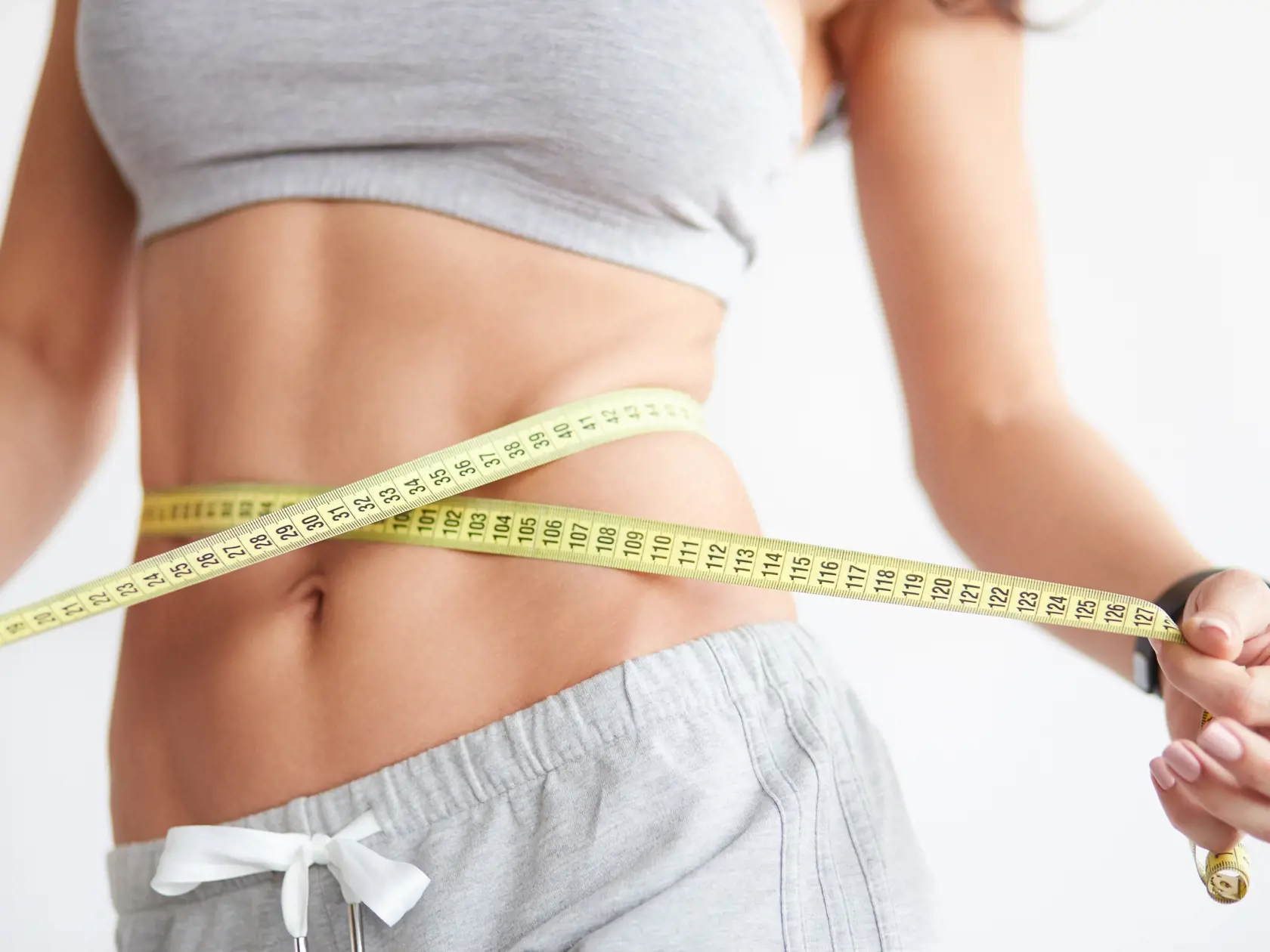 Slim,Girl,With,Centimeter,On,White.,Closeup,Woman,Measuring,Her