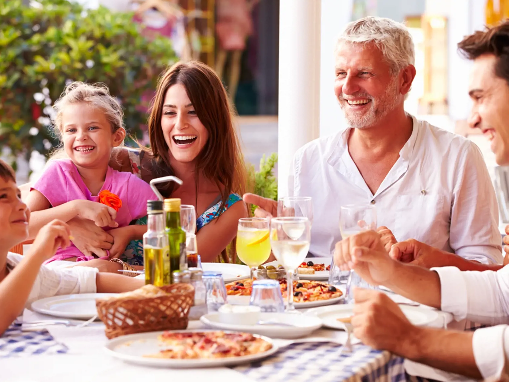 Multi,Generation,Family,Eating,Meal,At,Outdoor,Restaurant