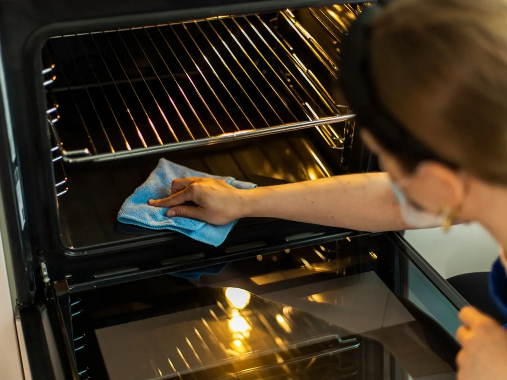 Cleaning,Lady,In,Gloves,Washing,Oven,In,Stylish,Kitchen.,Close-up