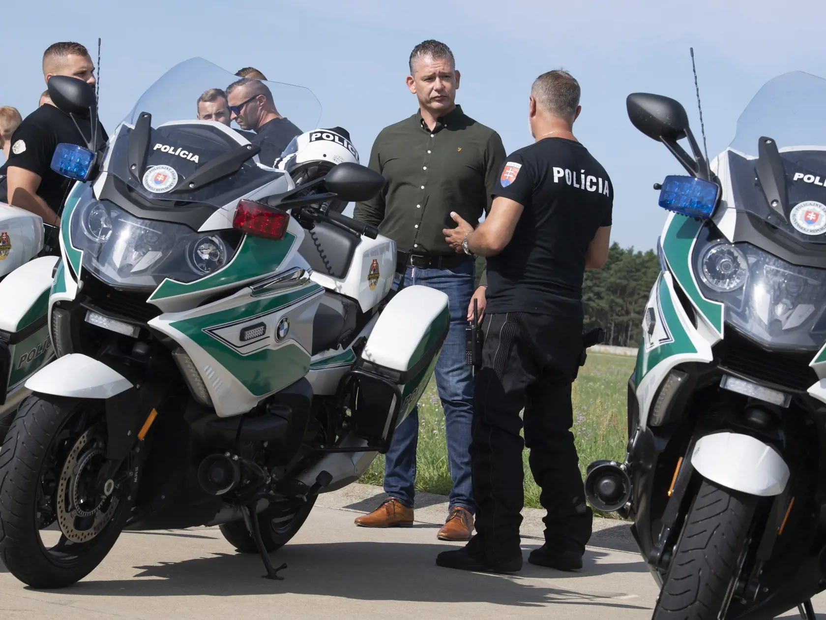 Na snímke druhý sprava minister vnútra Roman Mikulec (OĽaNO) počas odovzdávania nových motocyklov Úradu pre ochranu ústavných činiteľov a diplomatických misií Ministerstva vnútra (MV) SR v priestoroch leteckej základne Malacky-Kuchyňa v stredu 11. augusta 2021.