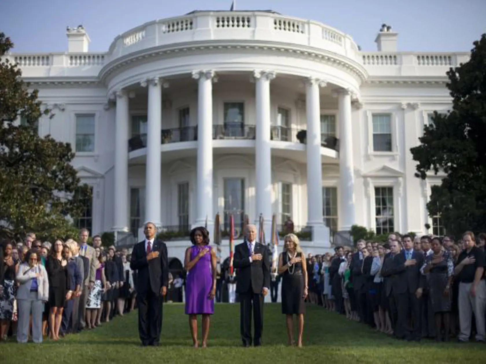 President Barack Obama, first lady Michelle Obama Vice President Joe Biden and Jill Biden join members of the White House staff as a military bugler played Taps to mark the 12th anniversary of the 9/11 attacks, Wednesday, Sept. 11, 2013 on the South Lawn of the White House in Washington. (AP Photo/Pablo Martinez Monsivais)