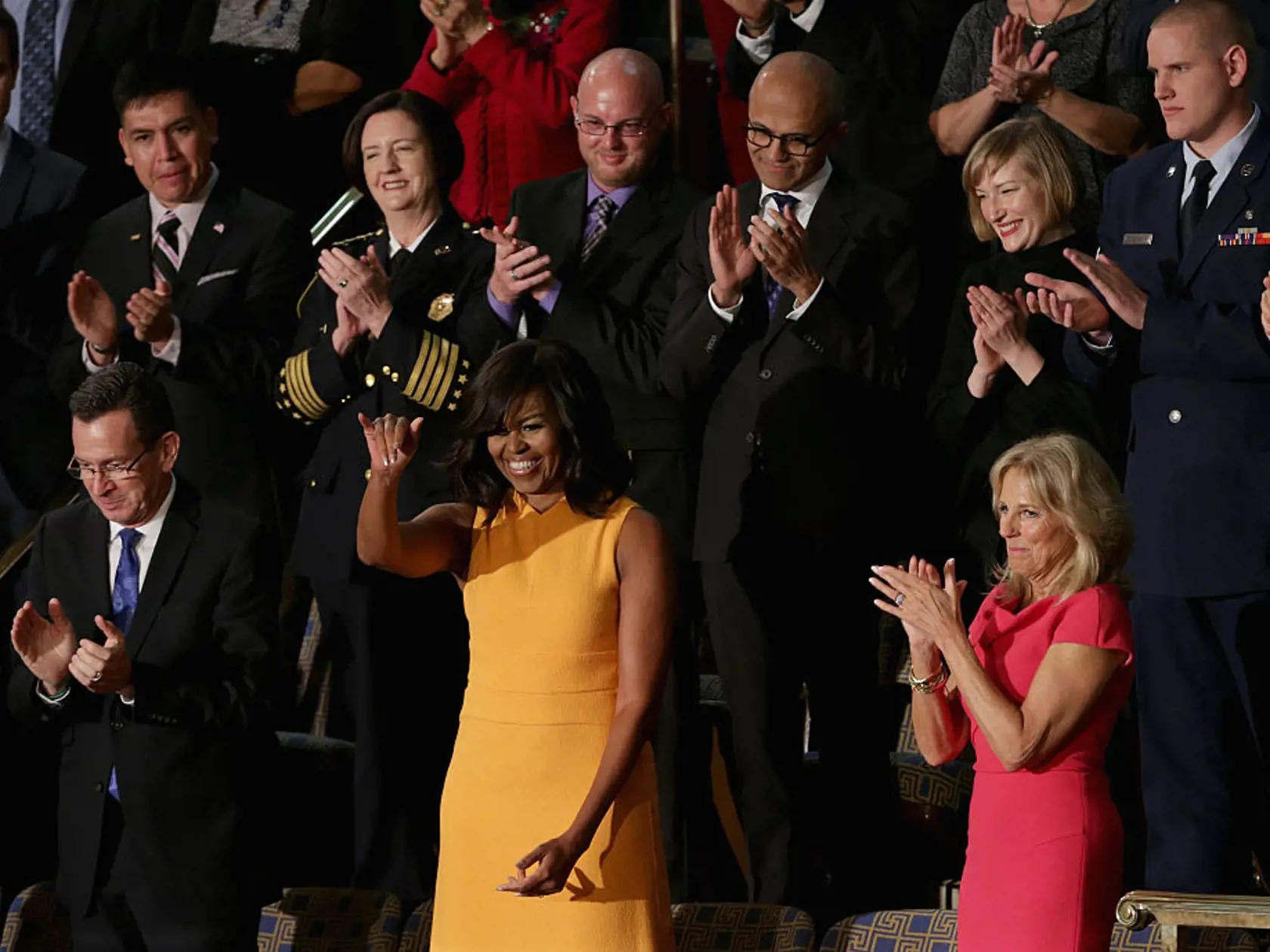 WASHINGTON, DC - JANUARY 12:  First lady Michelle Obama (C) waves to members of the congress as Gov. Dannel P. Malloy of Connecticut (L), and Wife of U.S. Vice President Joe Biden, Dr. Jill Biden (R) look on before US President Barack Obama delivers the State of the Union speech before members of Congress in the House chamber of the U.S. Capitol January 12, 2016 in Washington, DC.  (Photo by Alex Wong/Getty Images)