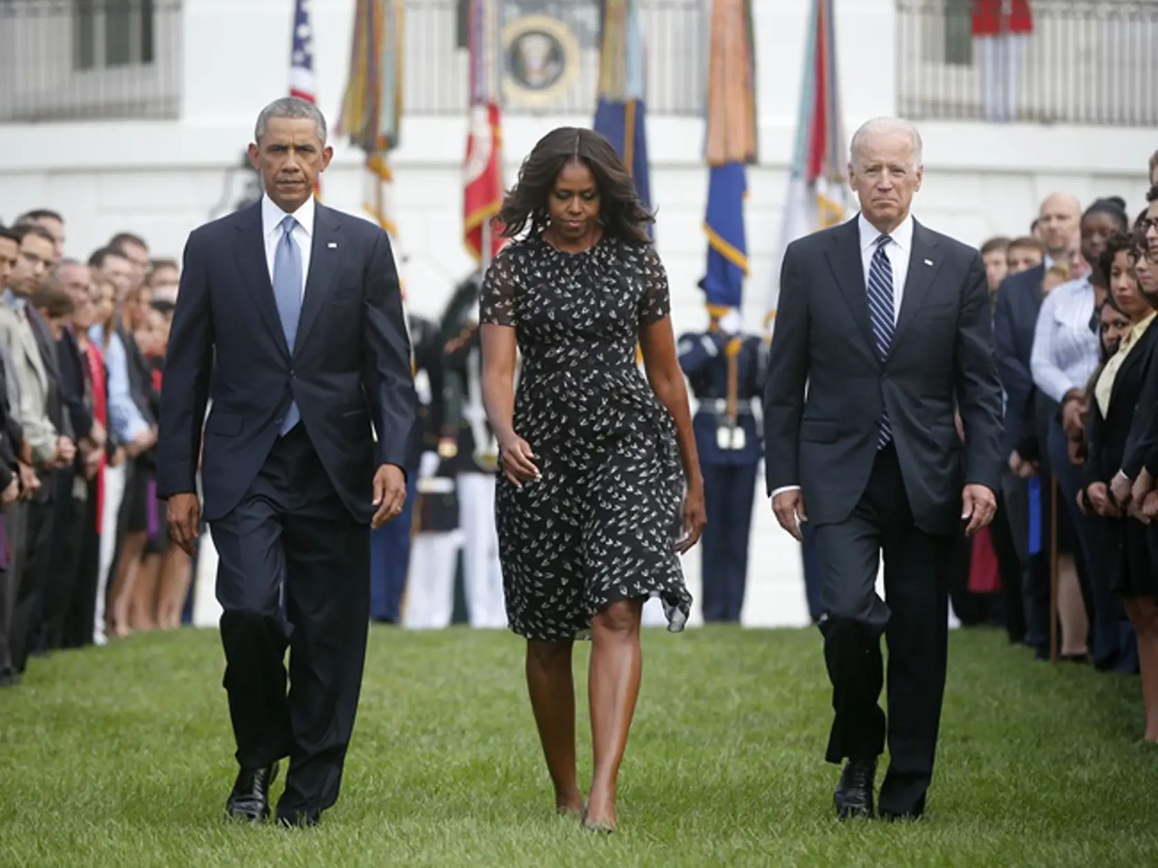 President Barack Obama, first lady Michelle Obama and Vice President Joe Biden walk on the South Lawn of the White House in Washington, Thursday, Sept. 11, 2014, to observe a moment of silence to mark the 13th anniversary of the 9/11 attack. (AP Photo/Charles Dharapak)