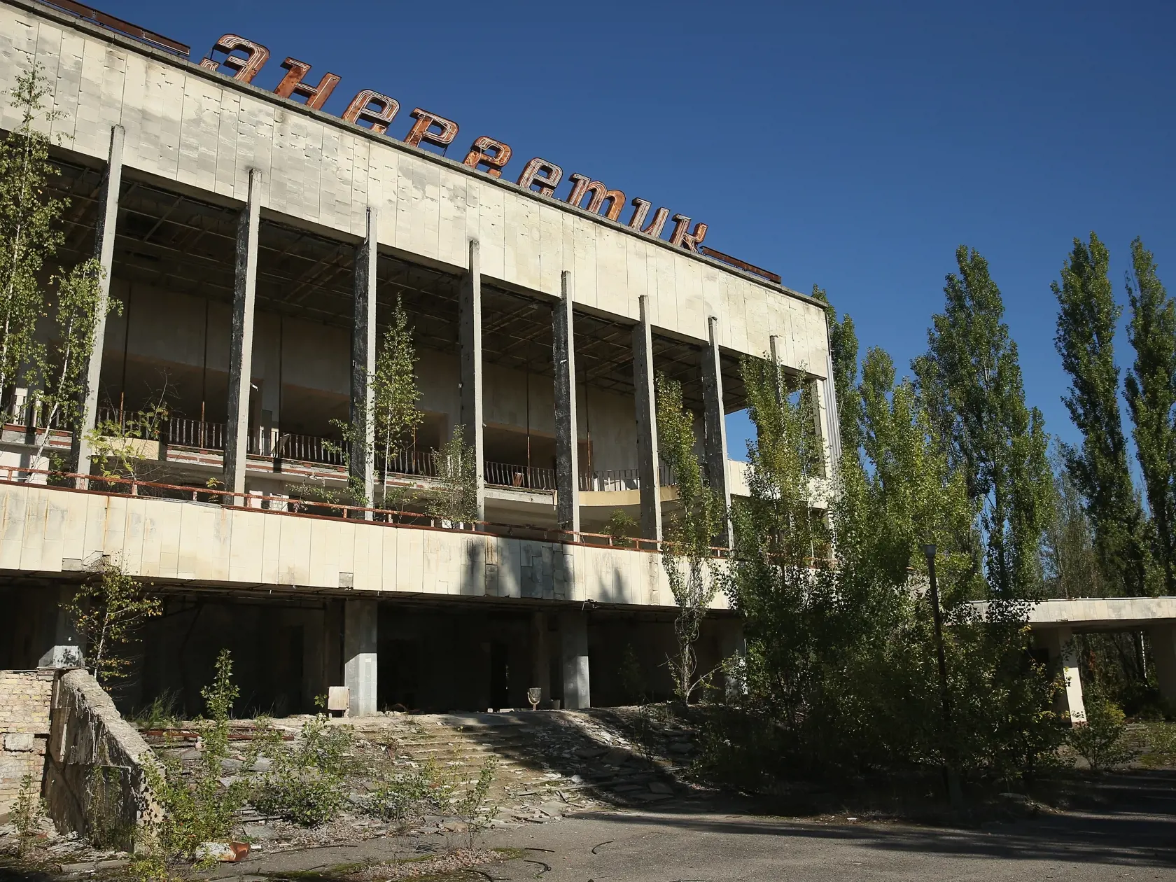PRIPYAT, UKRAINE - SEPTEMBER 30:  The abandoned "Energetik" cultural center, that once housed a library, lecture halls and sports facilities,  stands on the former main square overgrown with trees on September 30, 2015 in Pripyat, Ukraine. Pripyat lies only a few kilometers from the former Chernobyl nuclear power plant and was built in the 1970s to house the plant's workers and their families. On April 26, 1986, technicians at Chernobyl conducting a test inadvertently caused reactor number four 