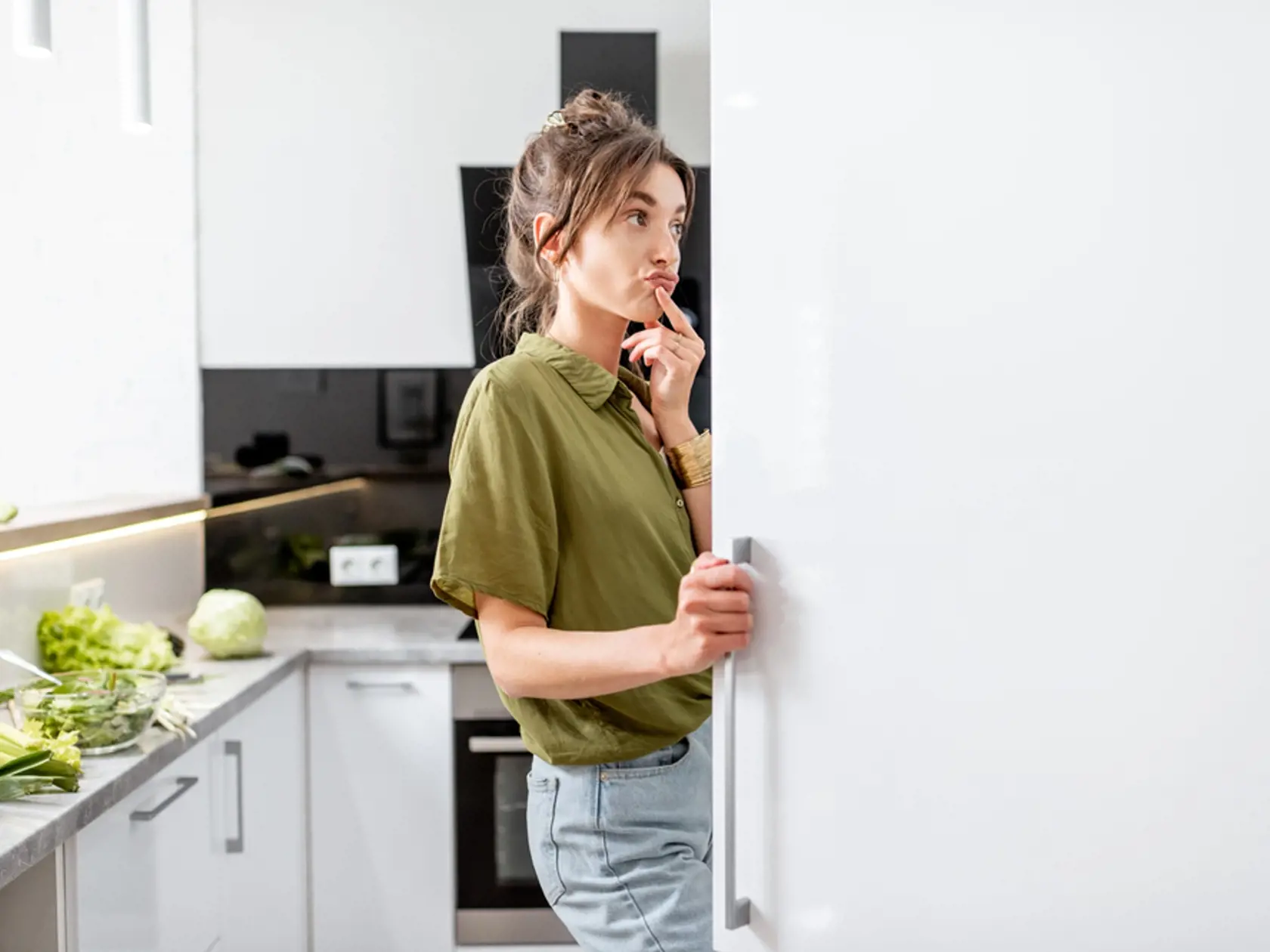 Woman,Looking,Into,The,Fridge,While,Cooking,Healthy,Food,On